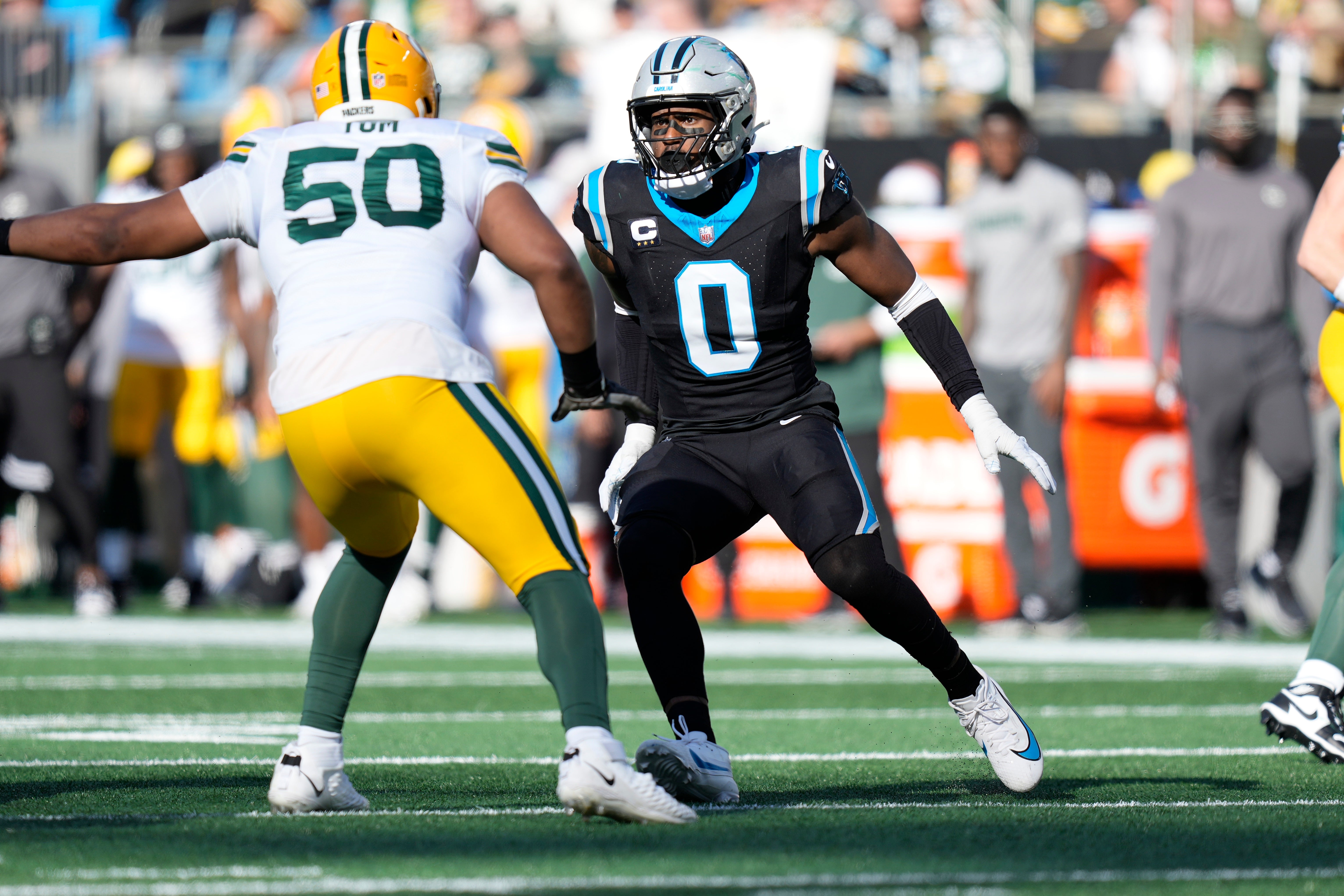 Dec 24, 2023; Charlotte, North Carolina, USA; Carolina Panthers linebacker Brian Burns (0) on the edge against Green Bay Packers guard Zach Tom (50) during the second quarter at Bank of America Stadium. Mandatory Credit: Jim Dedmon-USA TODAY Sports
