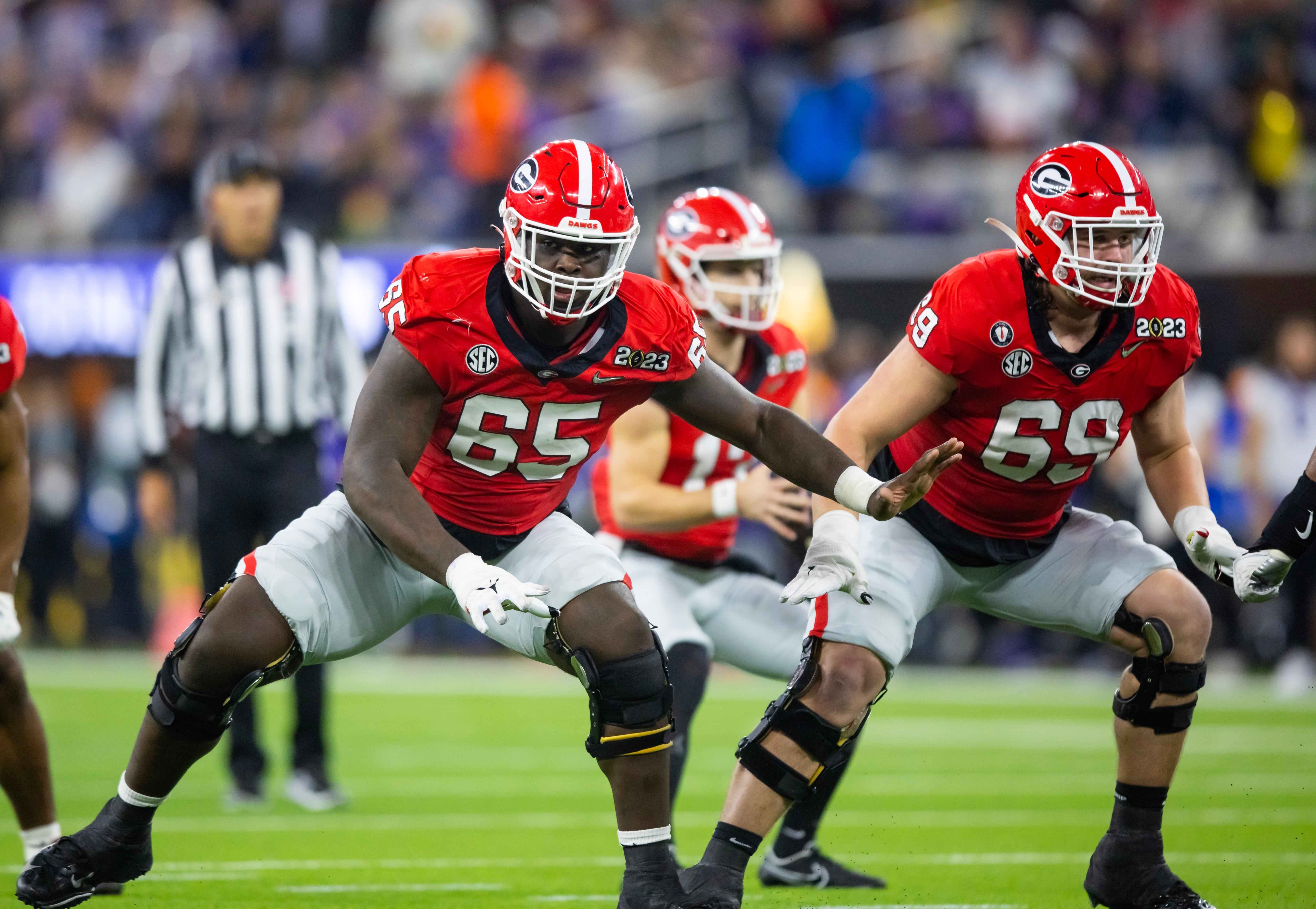 Jan 9, 2023; Inglewood, CA, USA; Georgia Bulldogs offensive lineman Amarius Mims (65) and offensive lineman Tate Ratledge (69) against the TCU Horned Frogs during the CFP national championship game at SoFi Stadium.