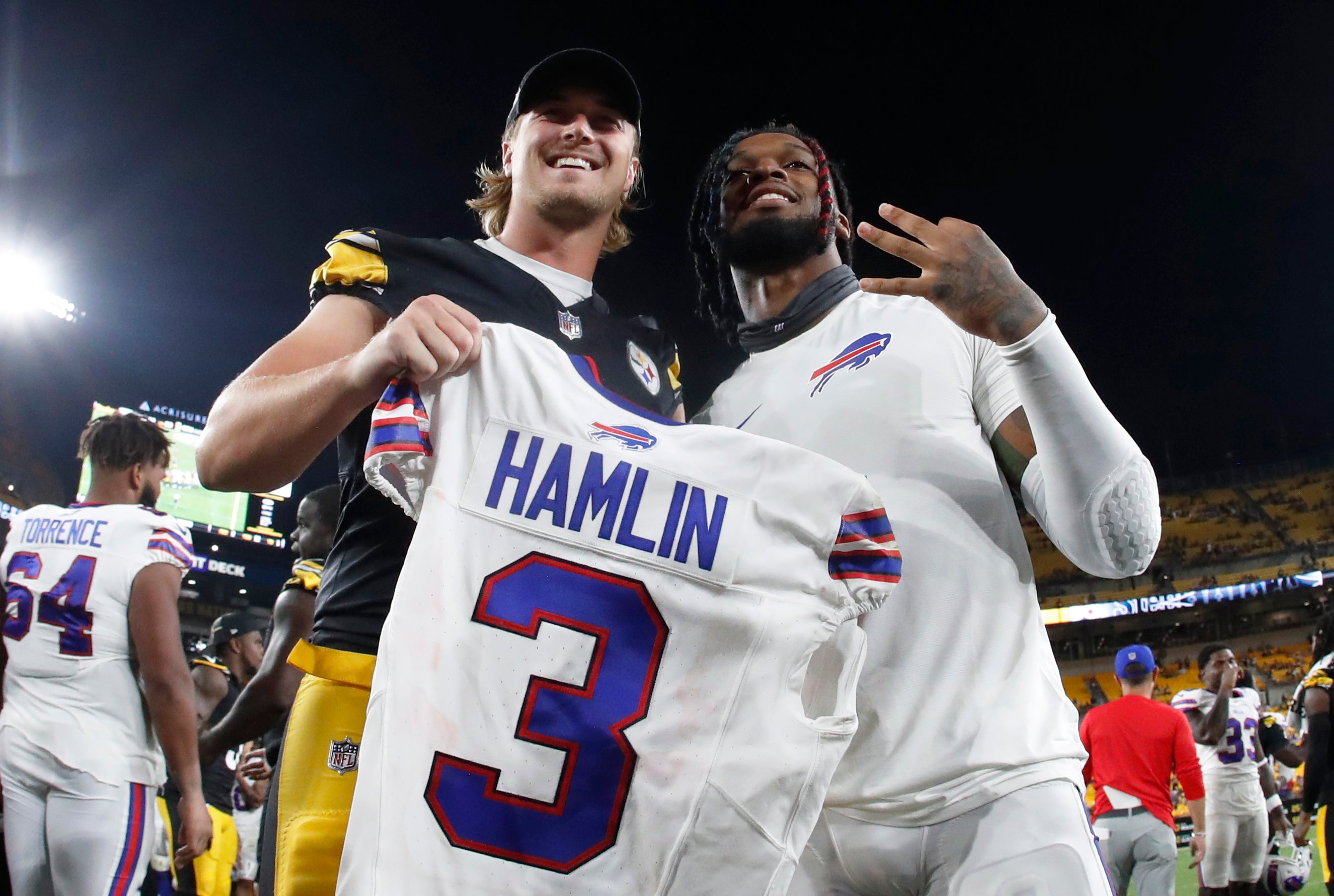 Aug 19, 2023; Pittsburgh, Pennsylvania, USA; Pittsburgh Steelers quarterback Kenny Pickett (left) and Buffalo Bills safety Damar Hamlin (right) pose for a photo after Hamlin gifted his game jersey to Pickett after their game at Acrisure Stadium. Pittsburgh won 27-15. Mandatory Credit: Charles LeClaire-USA TODAY Sports