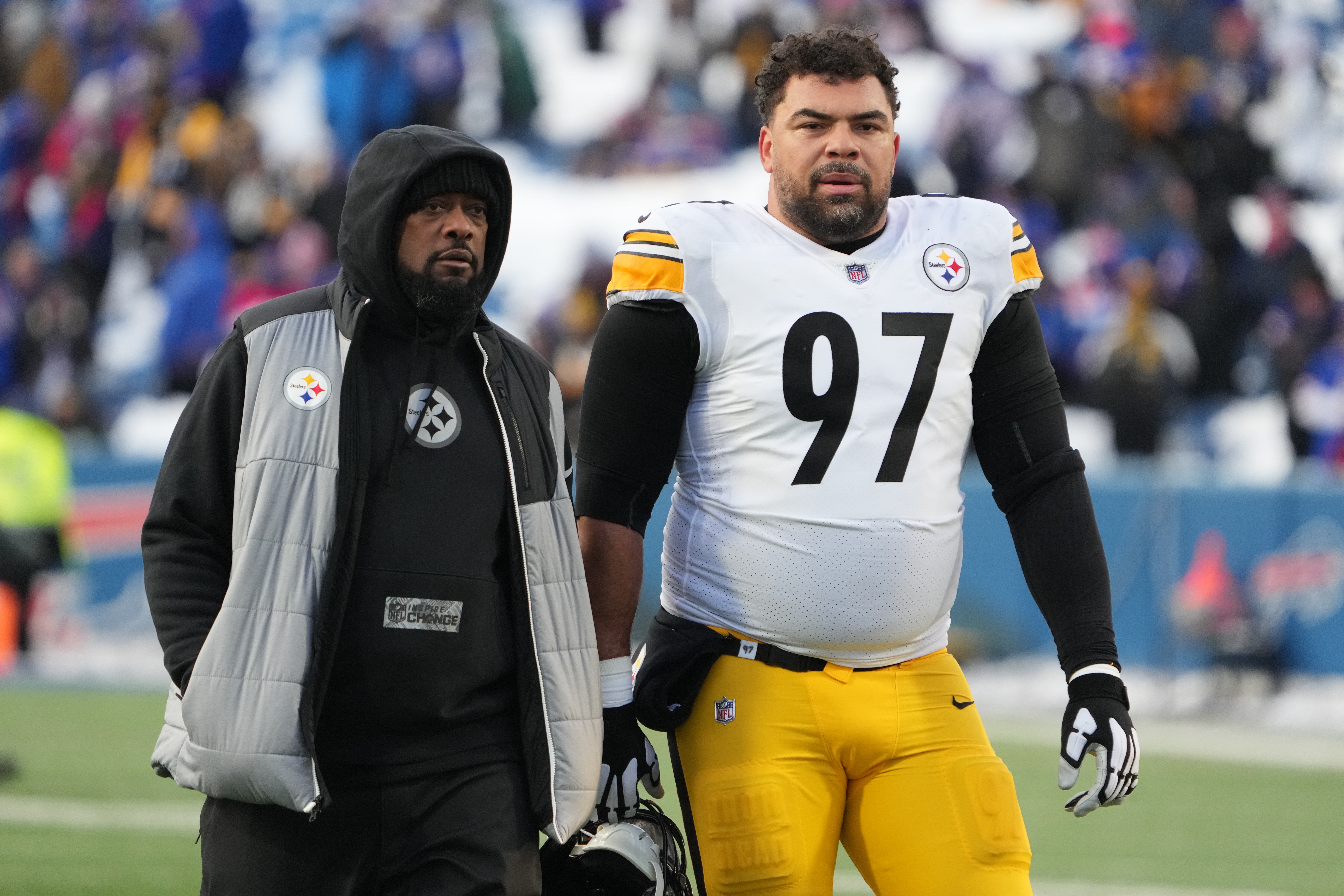 Jan 15, 2024; Orchard Park, New York, USA; Pittsburgh Steelers head coach Mike Tomlin walks the field with defensive tackle Cameron Heyward (97) before the game against the Buffalo Bills in a 2024 AFC wild card game at Highmark Stadium. Mandatory Credit: Kirby Lee-USA TODAY Sports  