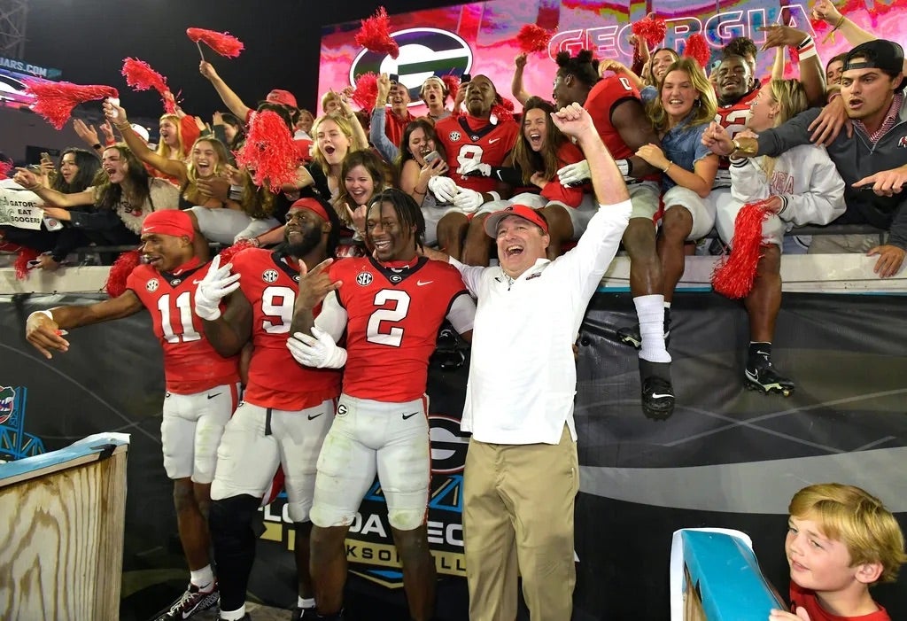 Georgia Bulldogs head coach Kirby Smart celebrates with his players and fans after their victory over Florida. The annual Georgia vs Florida football rivalry was held at TIAA Bank Field.