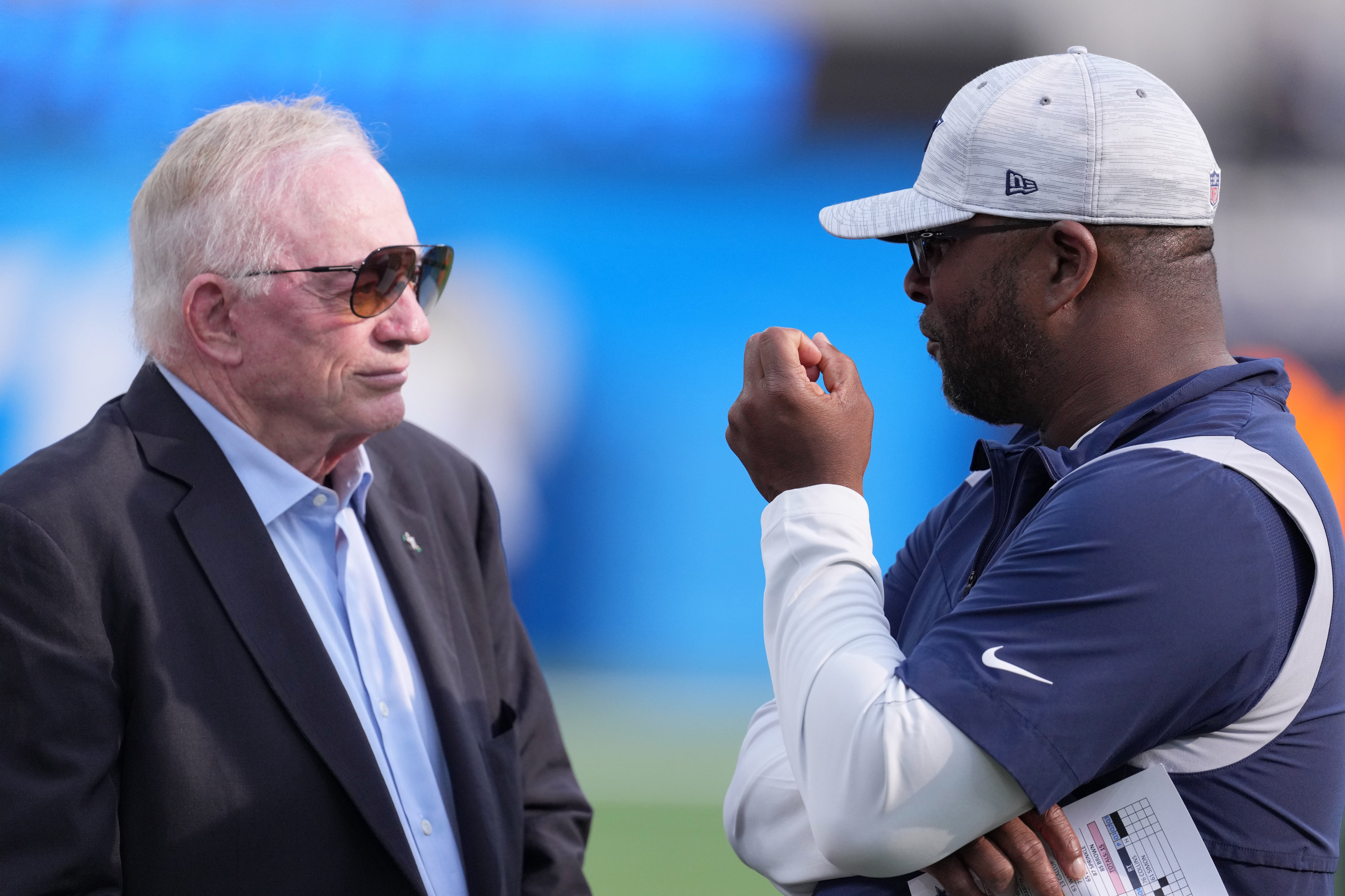 Dallas Cowboys owner Jerry Jones (left) talks with vice president of player personnel Will McClay before the game against the Los Angeles Chargers at SoFi Stadium.