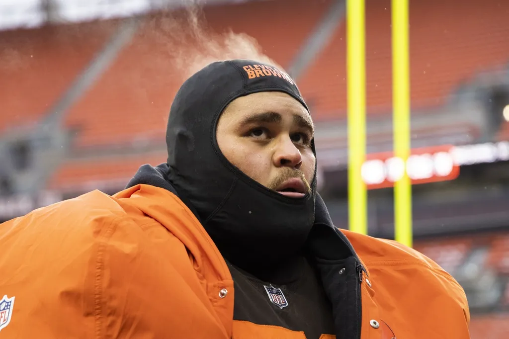 Steam comes off the head of Cleveland Browns offensive tackle Jedrick Wills Jr. (71) as he walks off the field following the game against the New Orleans Saints at FirstEnergy Stadium.