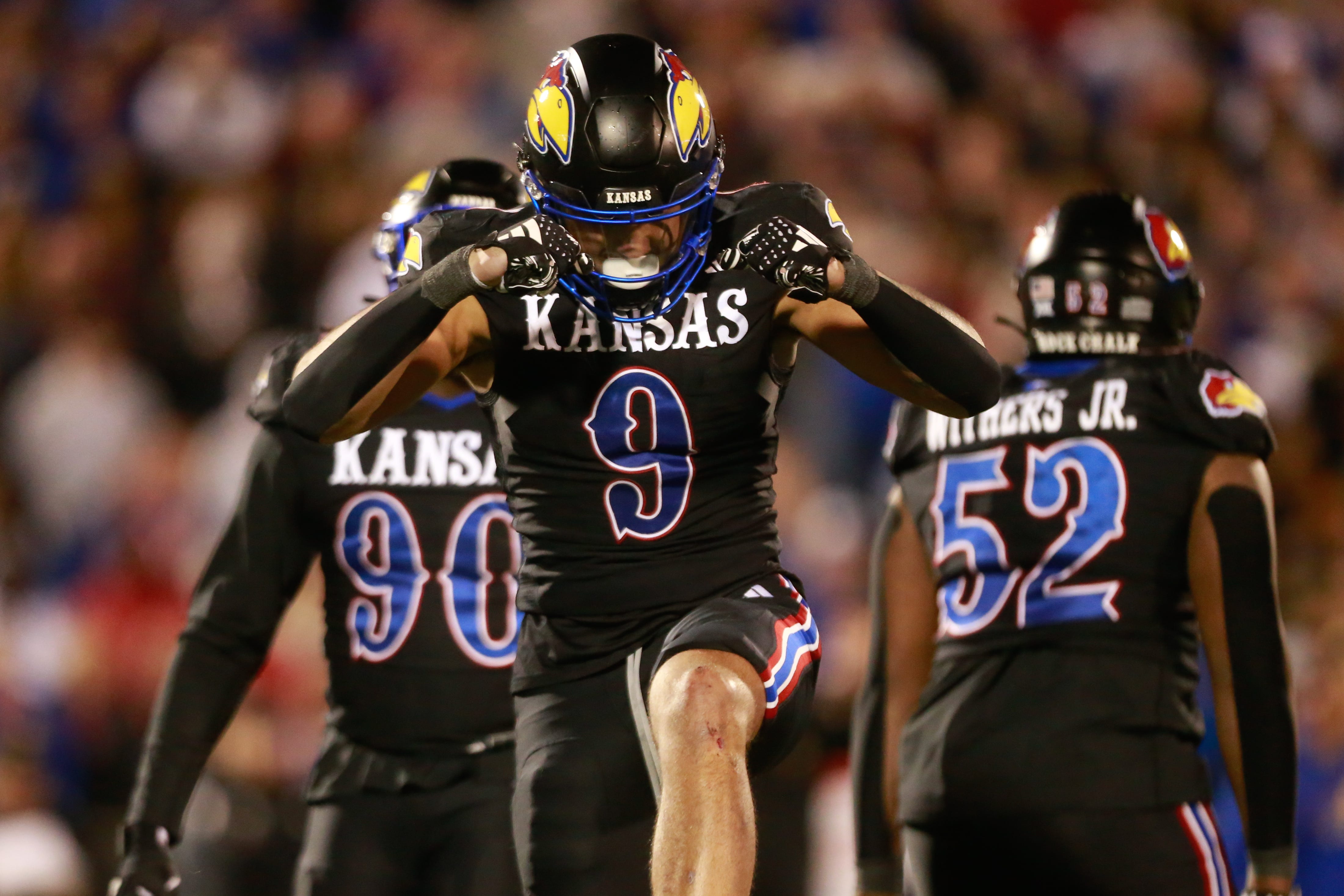 Kansas redshirt sophomore defensive lineman Austin Booker (9) reacts after a sack in the fourth quarter of Saturday's Sunflower Showdown against Kansas State inside David Booth Kansas Memorial Stadium.