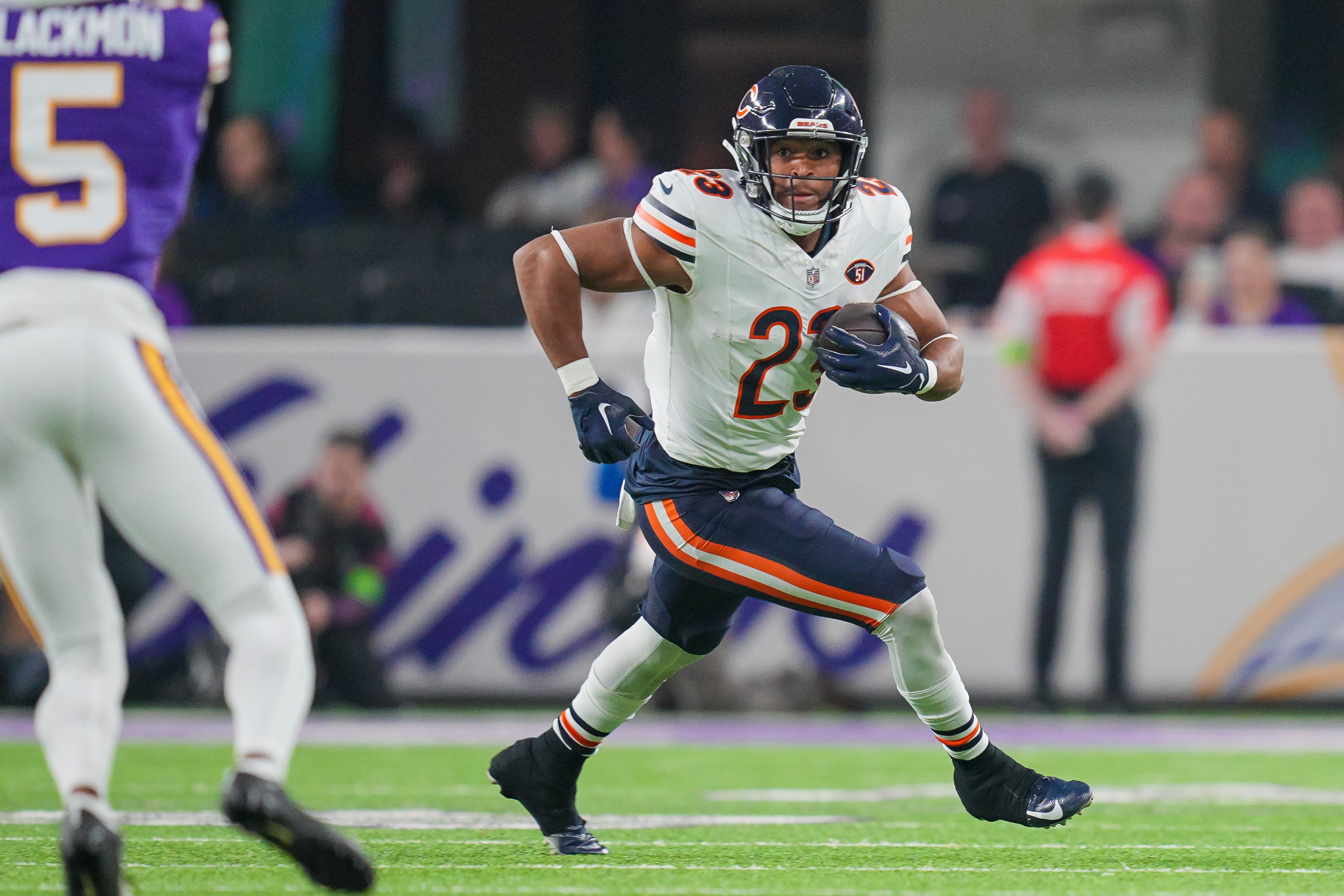 Nov 27, 2023; Minneapolis, Minnesota, USA; Chicago Bears running back Roschon Johnson (23) runs with the ball against the Minnesota Vikings in the first quarter at U.S. Bank Stadium.