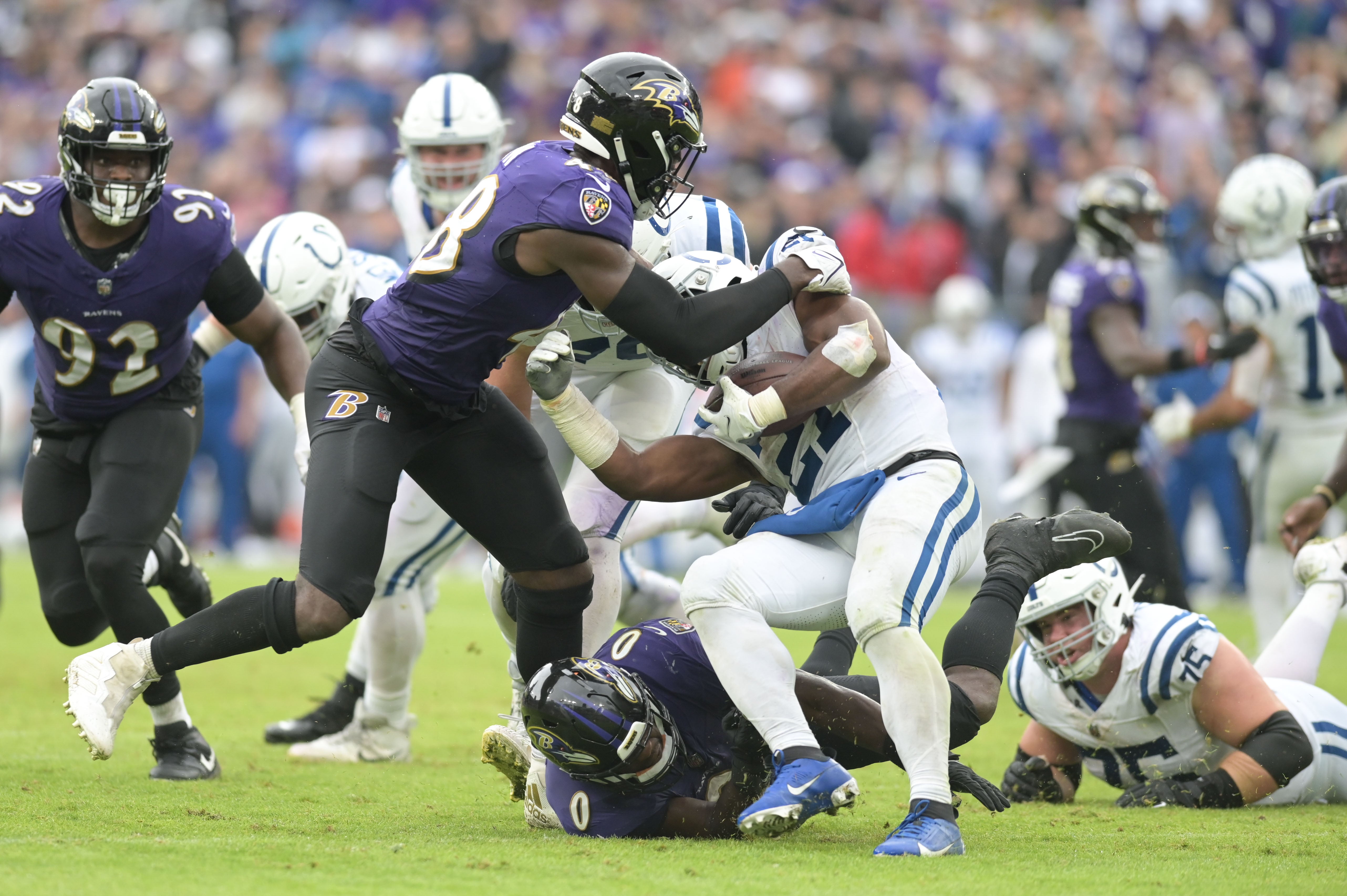Baltimore Ravens linebacker Jeremiah Moon (48) and linebacker Roquan Smith (0) tackle Indianapolis Colts running back Zack Moss (21) during the second half at M&T Bank Stadium.