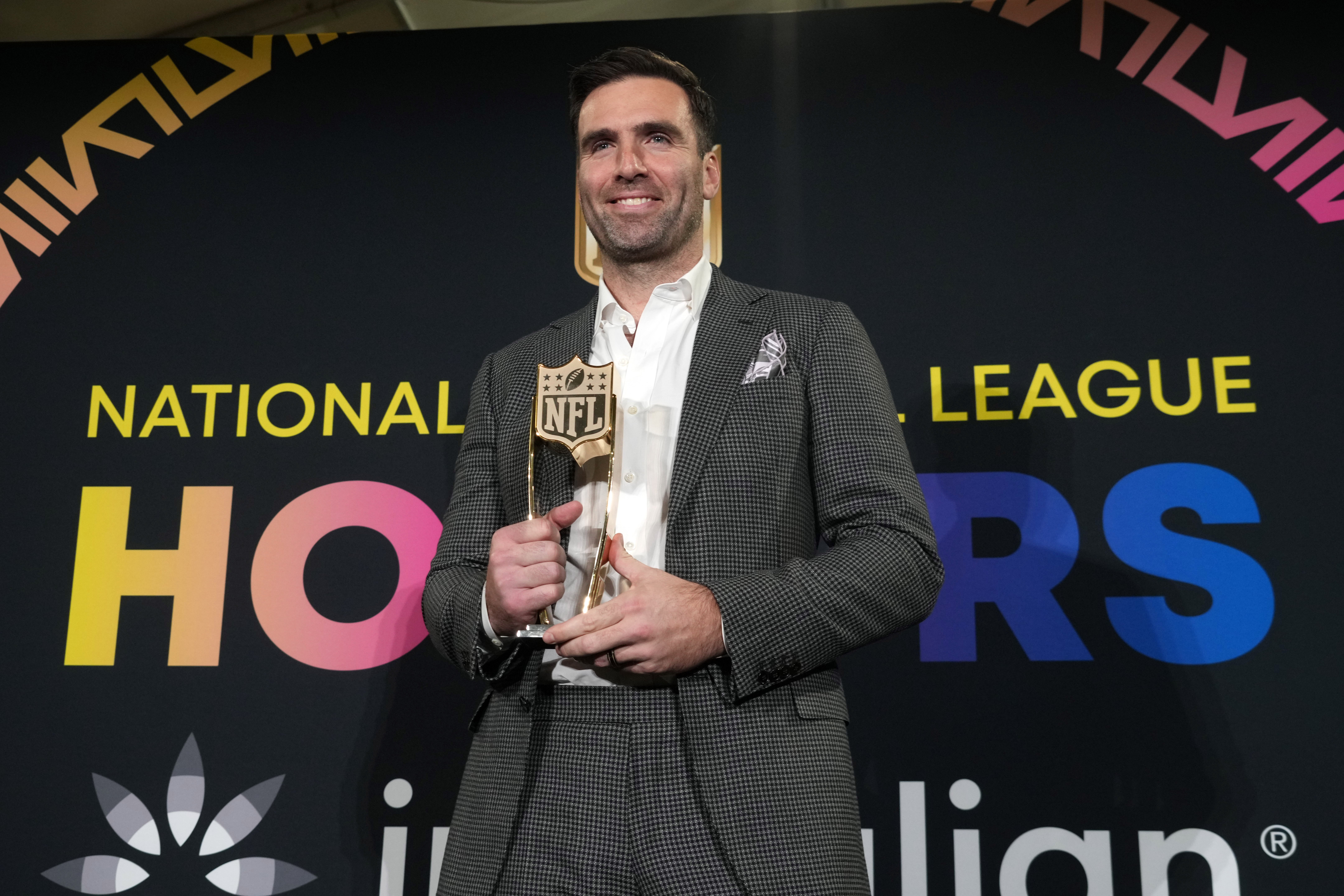 Feb 8, 2024; Las Vegas, NV, USA; Cleveland Browns quarterback Joe Flacco poses with the Comeback Player of the Year award during the Pro Football Hall of Fame Class of 2024 press conference at the Resorts World Theatre.
