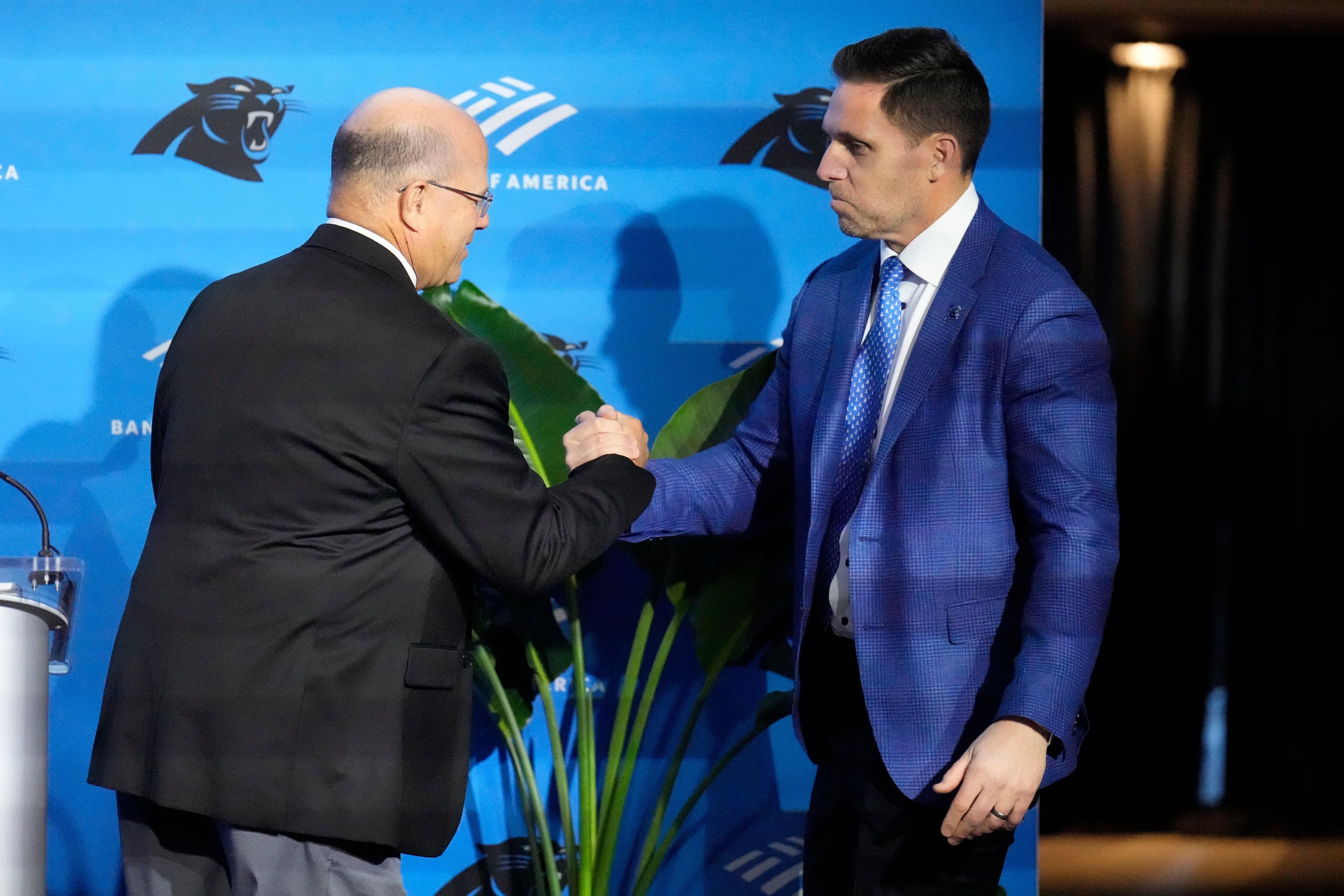 Feb 1, 2024; Charlotte, NC, USA; Carolina Panthers team owner David Tepper greets Dan Morgan during the introductory press conference for new general manager Dan Morgan and head coach Dave Canales at Bank of America Stadium. Mandatory Credit: Jim Dedmon-USA TODAY Sports