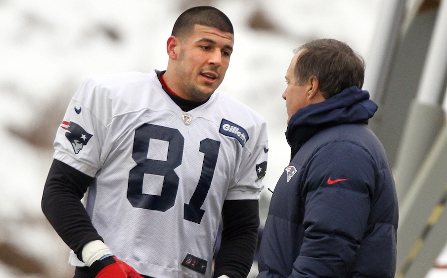 2013: Patriots head coach Bill Belichick talks with tight end Aaron Hernandez during practice.