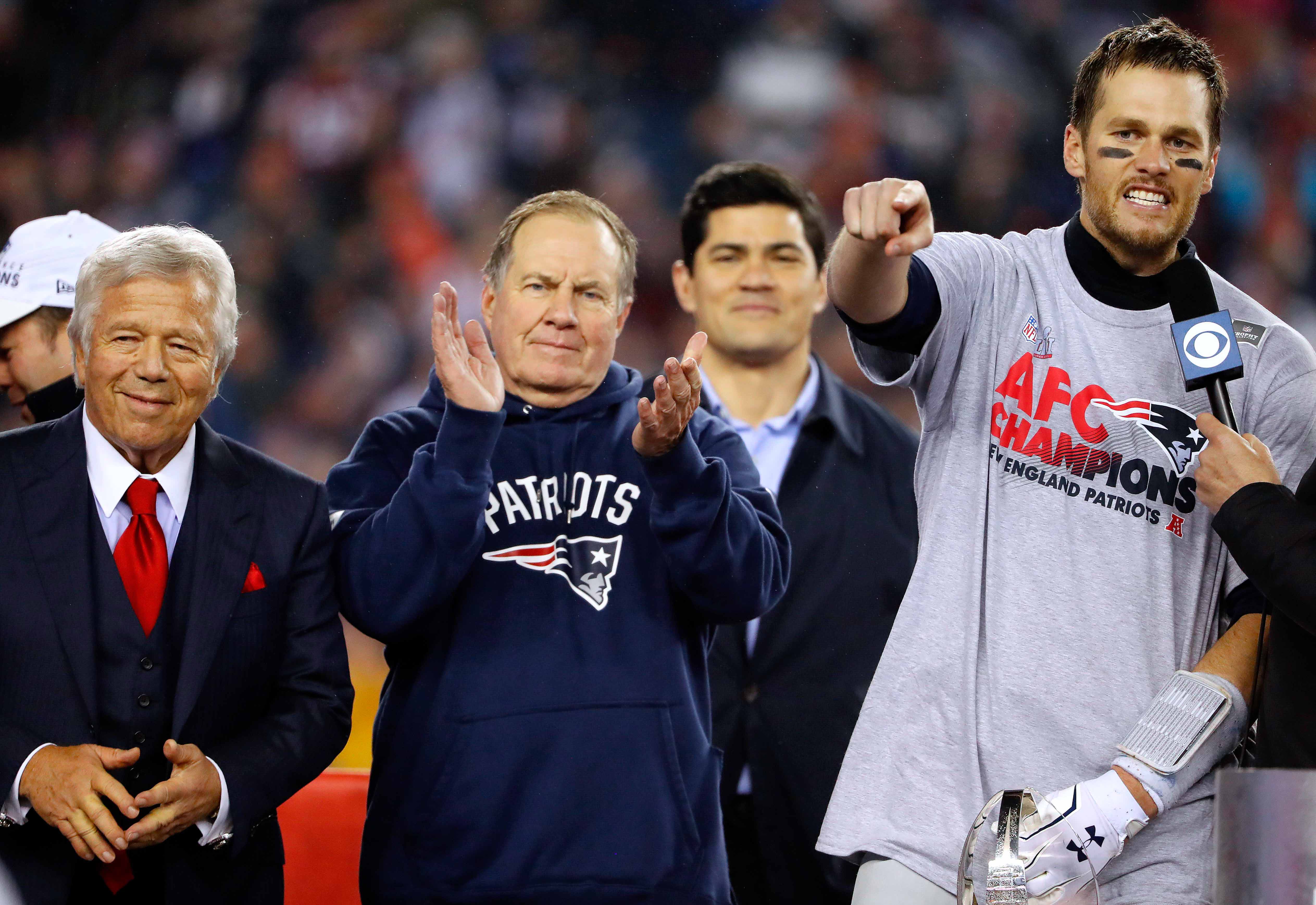 Jan 22, 2017; Foxborough, MA, USA; New England Patriots quarterback Tom Brady (12) points to teammates as head coach Bill Belichick and owner Robert Kraft look on after the 2017 AFC Championship Game against the Pittsburgh Steelers at Gillette Stadium.