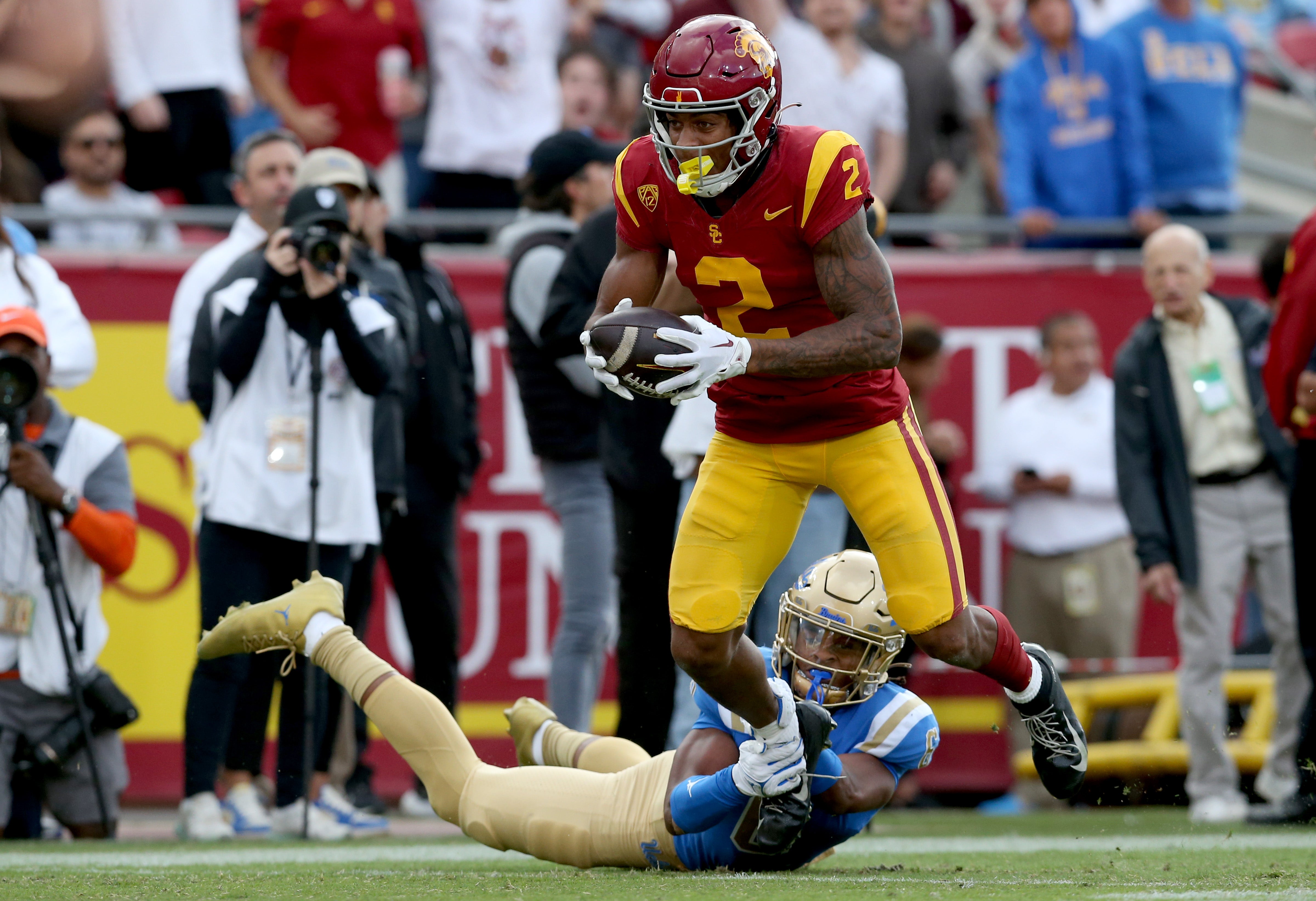 Nov 18, 2023; Los Angeles, California, USA; USC Trojans wide receiver Brenden Rice (2) runs after a catch against UCLA Bruins defensive back John Humphrey (6) during the third quarter at United Airlines Field at Los Angeles Memorial Coliseum.