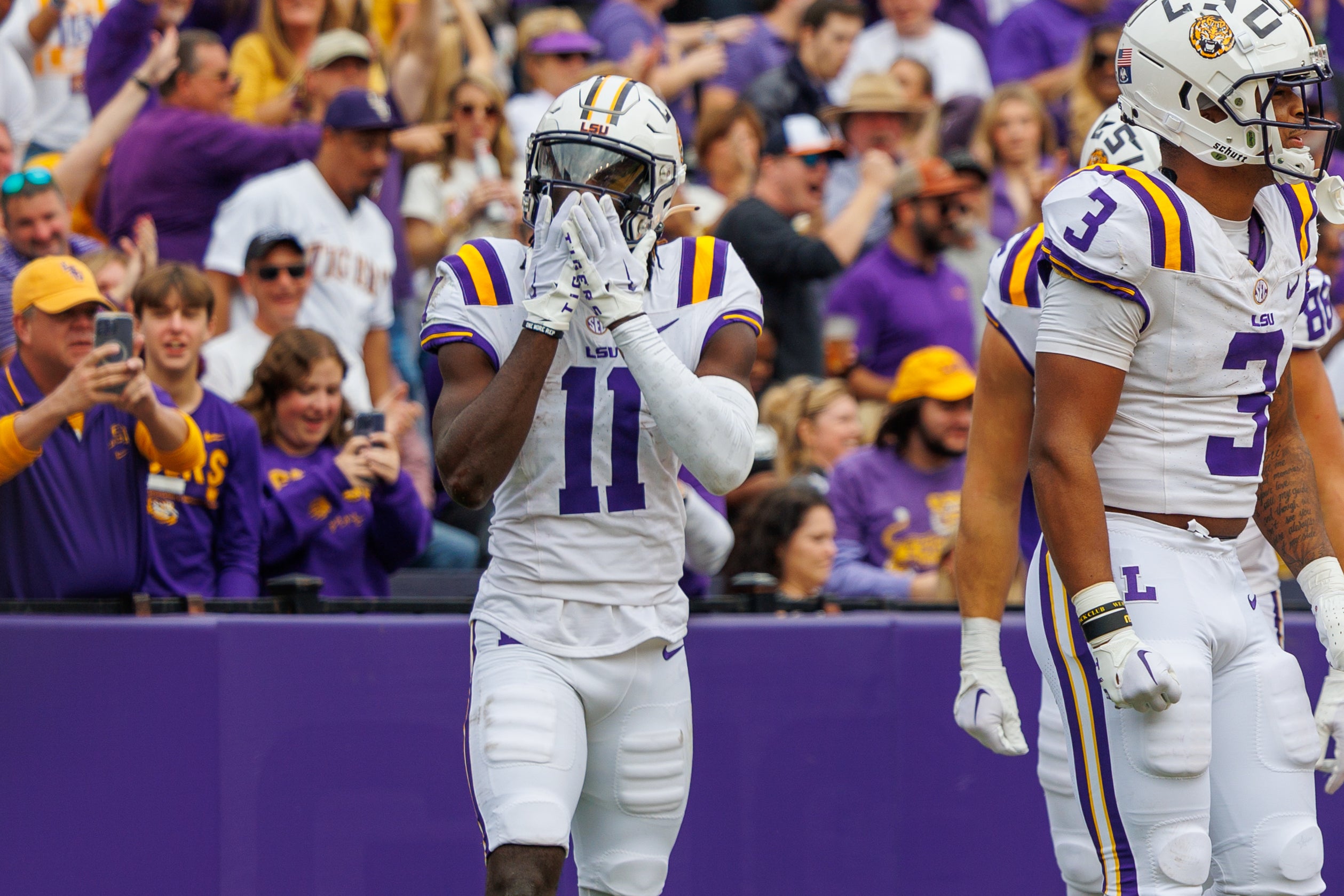 Nov 25, 2023; Baton Rouge, Louisiana, USA; LSU Tigers wide receiver Brian Thomas Jr. (11) catches a touchdown against Texas A&M Aggies defensive back Sam McCall (16) during the second half at Tiger Stadium. Mandatory Credit: Stephen Lew-USA TODAY Sports