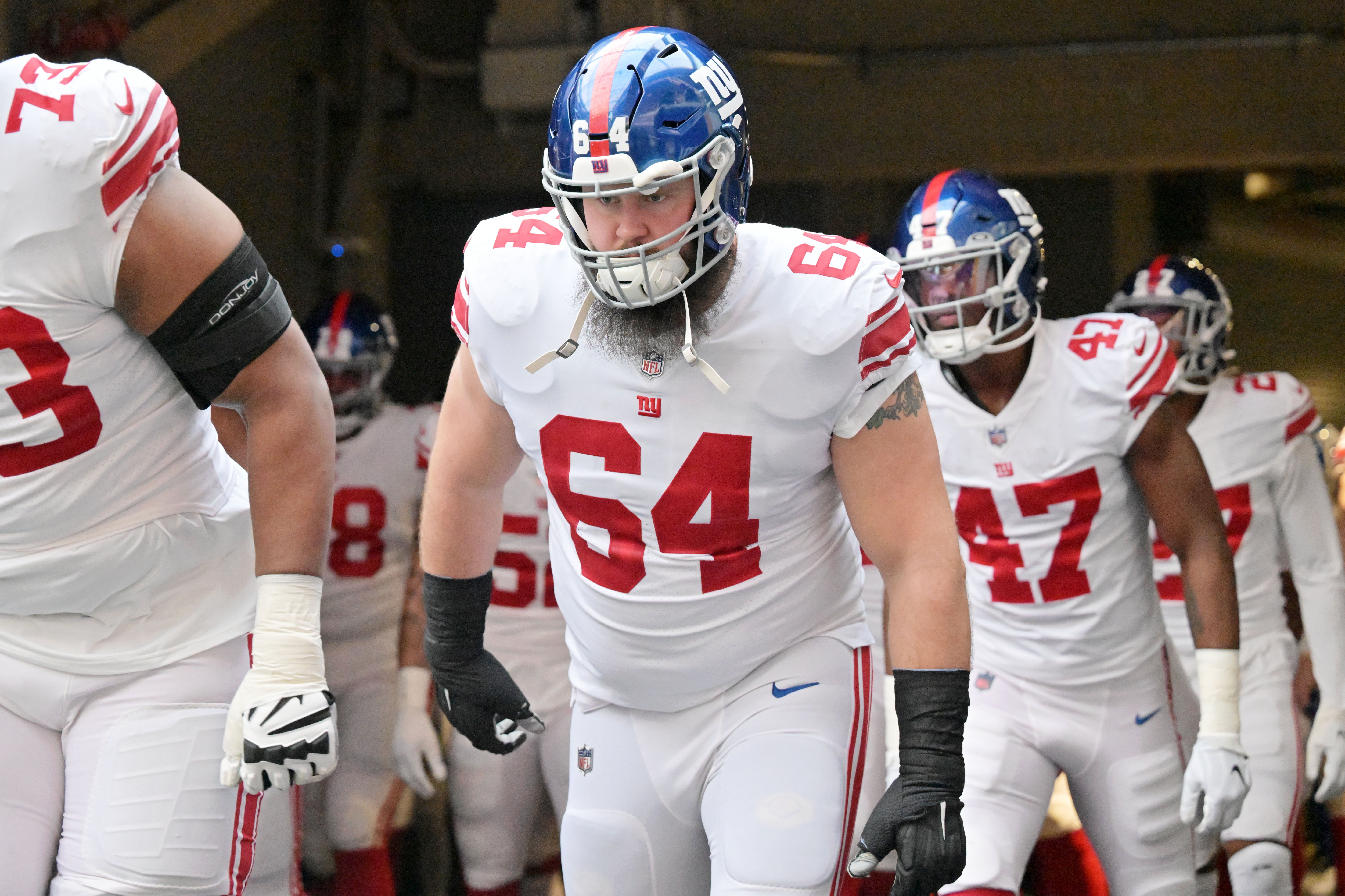 Jan 15, 2023; Minneapolis, Minnesota, USA; New York Giants guard Mark Glowinski (64) runs onto the field before a wild card game against the Minnesota Vikings at U.S. Bank Stadium.