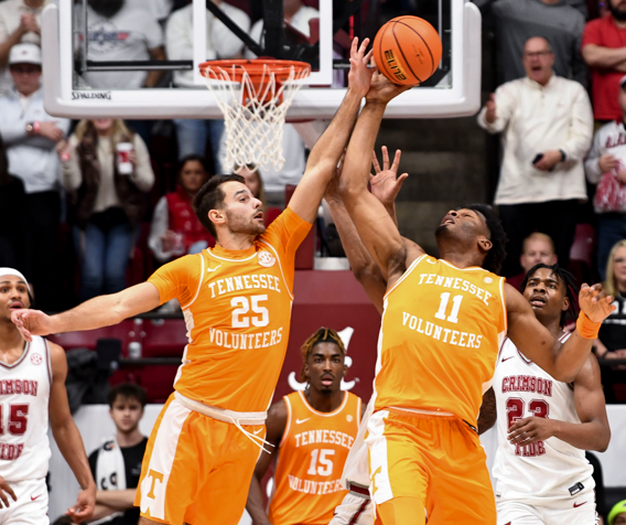 Mar 2, 2024; Tuscaloosa, Alabama, USA; Tennessee guard Santiago Vescovi (25) and Tennessee forward Tobe Awaka (11) grab an offensive rebound at Coleman Coliseum. Tennessee defeated Alabama 81-74. 