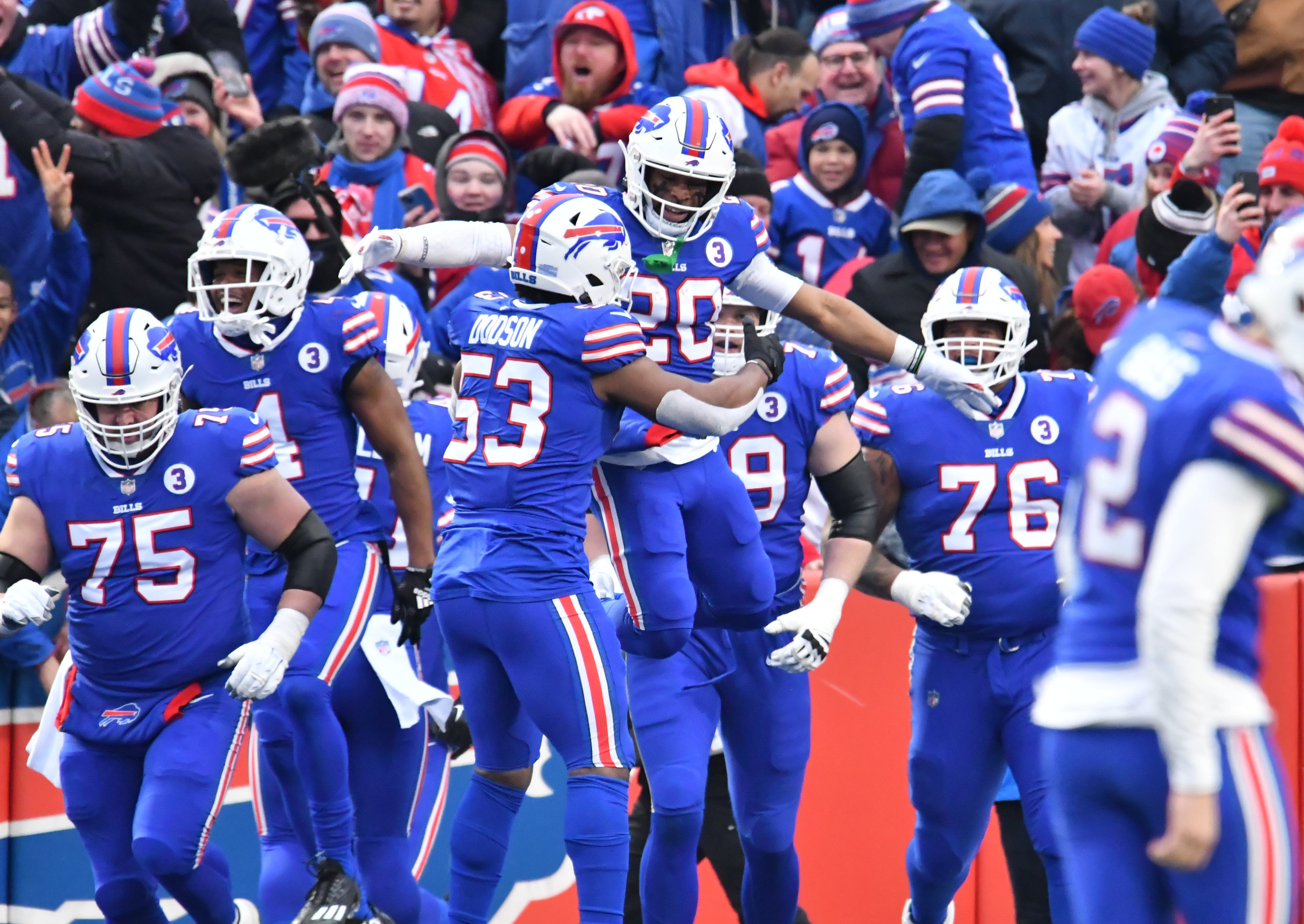 Buffalo Bills running back Nyheim Hines (20) is greeted by teammates after scoring his second kickoff return for a touchdown against the New England Patriots in the third quarter at Highmark Stadium.