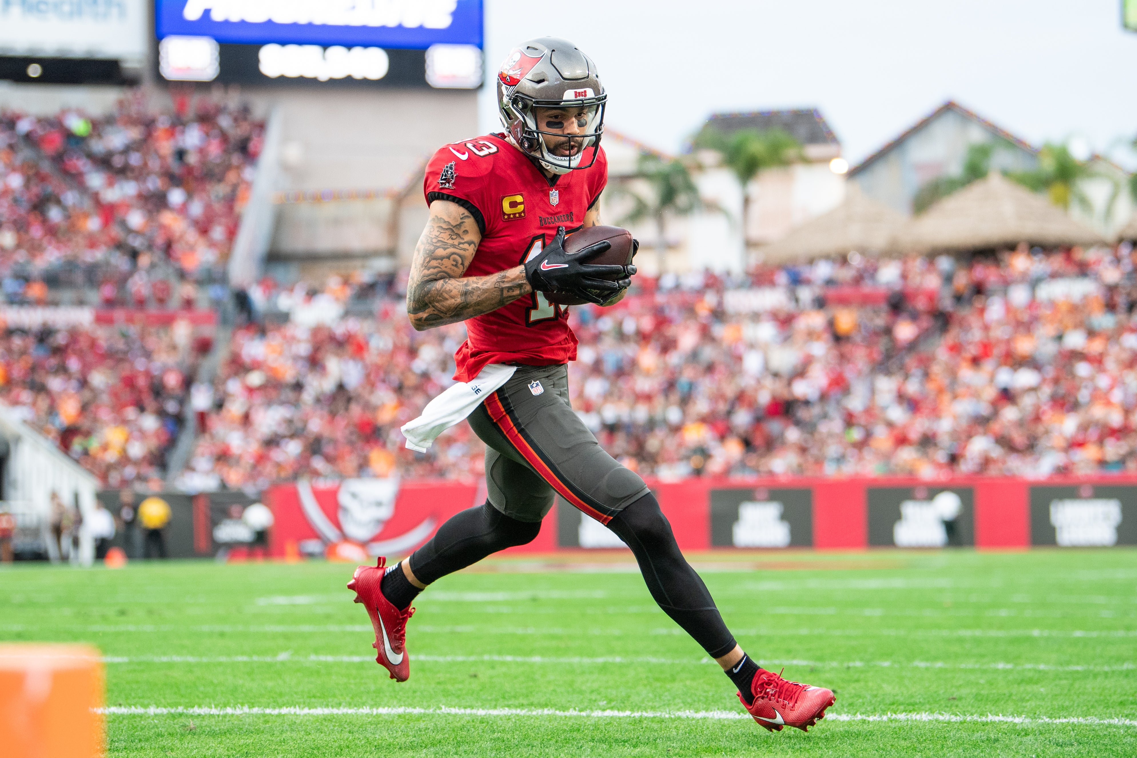 Dec 24, 2023; Tampa, Florida, USA;Tampa Bay Buccaneers wide receiver Mike Evans (13) catches the touchdown against the Jacksonville Jaguars in the second quarter at Raymond James Stadium.