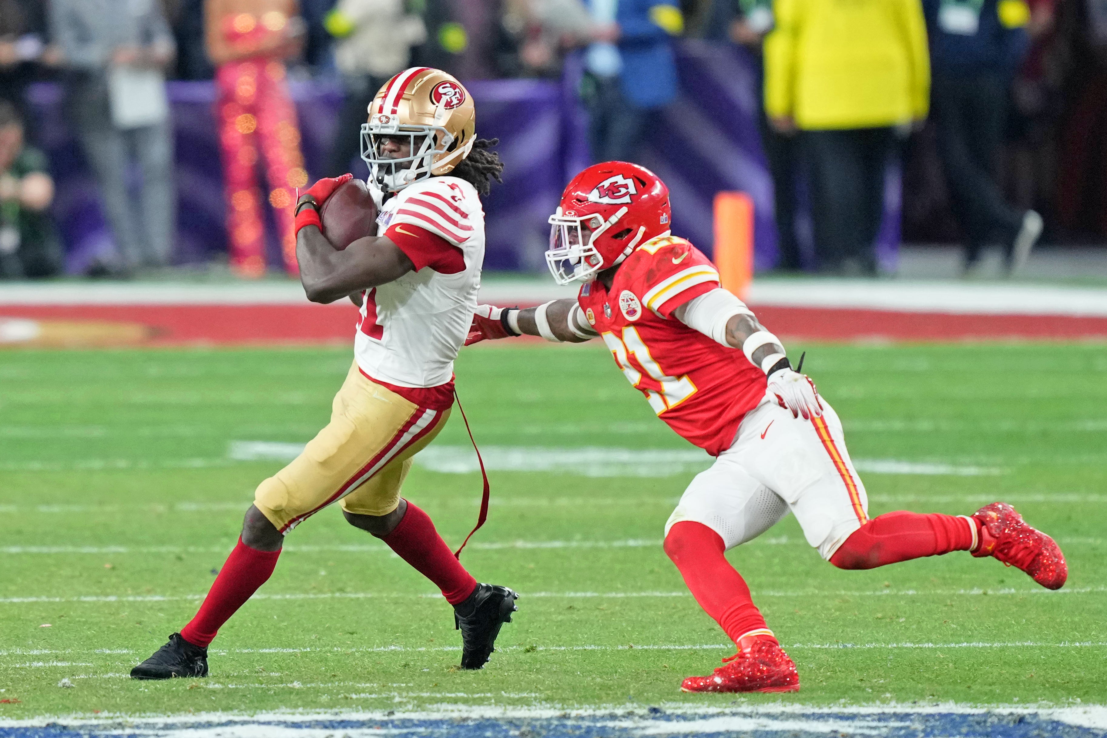 Feb 11, 2024; Paradise, Nevada, USA; San Francisco 49ers wide receiver Brandon Aiyuk (11) makes a catch against Kansas City Chiefs safety Mike Edwards (21) during overtime of Super Bowl LVIII at Allegiant Stadium.