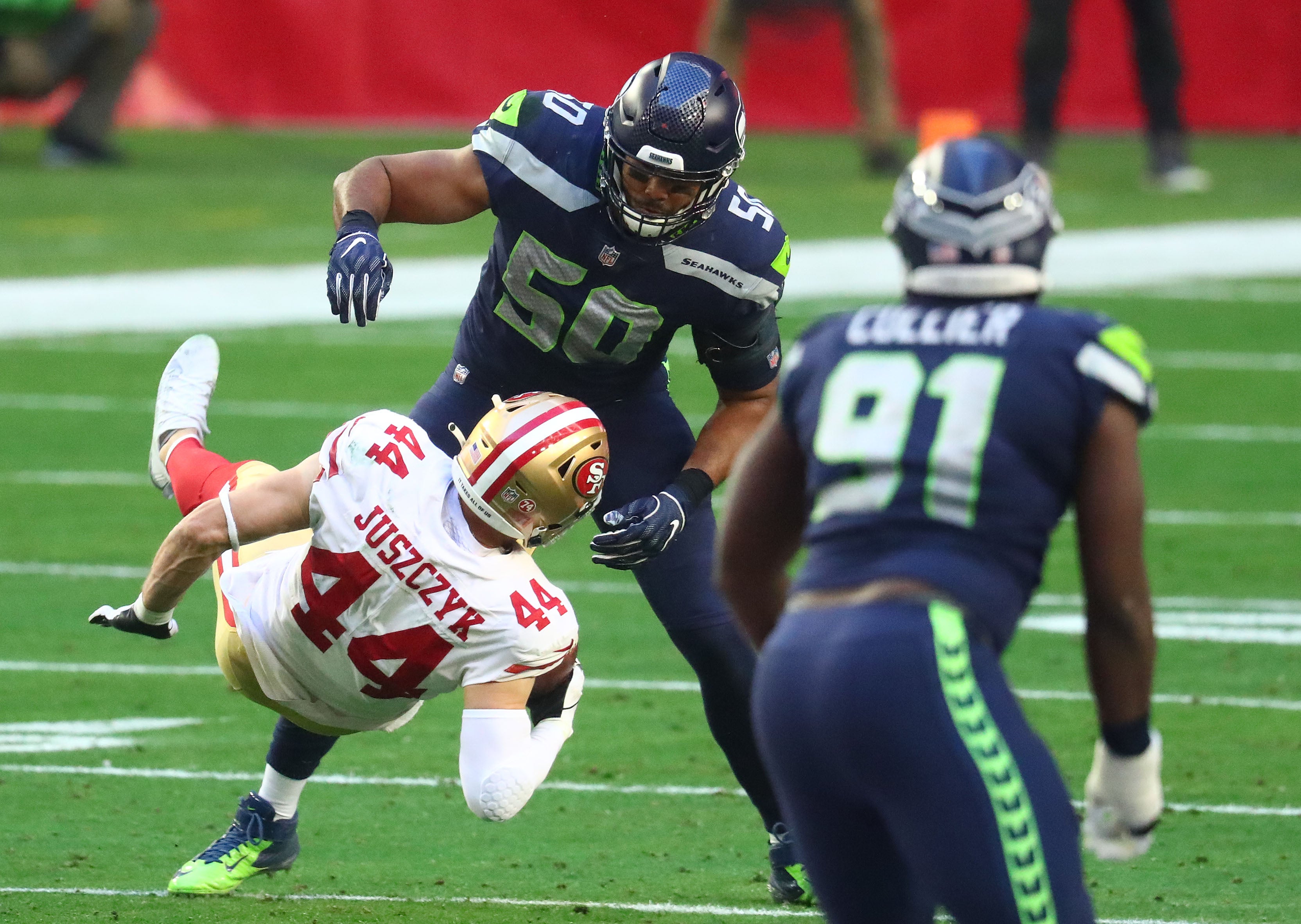 Jan 3, 2021; Glendale, Arizona, USA; San Francisco 49ers fullback Kyle Juszczyk (44) is brought down by Seattle Seahawks outside linebacker K.J. Wright (50) during the first half at State Farm Stadium.