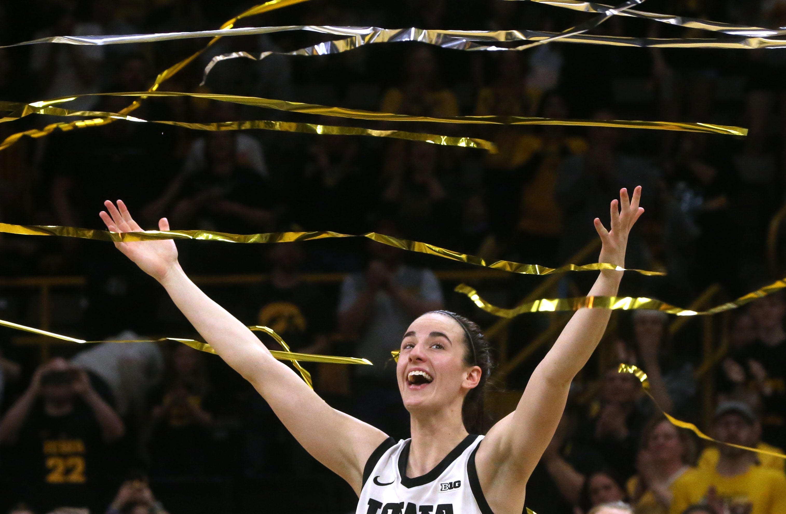 Caption: March 3: Caitlin Clark reacts as confetti rains down during Iowa's senior recognition after playing Ohio State at Carver-Hawkeye Arena in Iowa City, Iowa. Clark broke Pete Maravich's all-time NCAA scoring record in the Hawkeyes' 93-83 win.