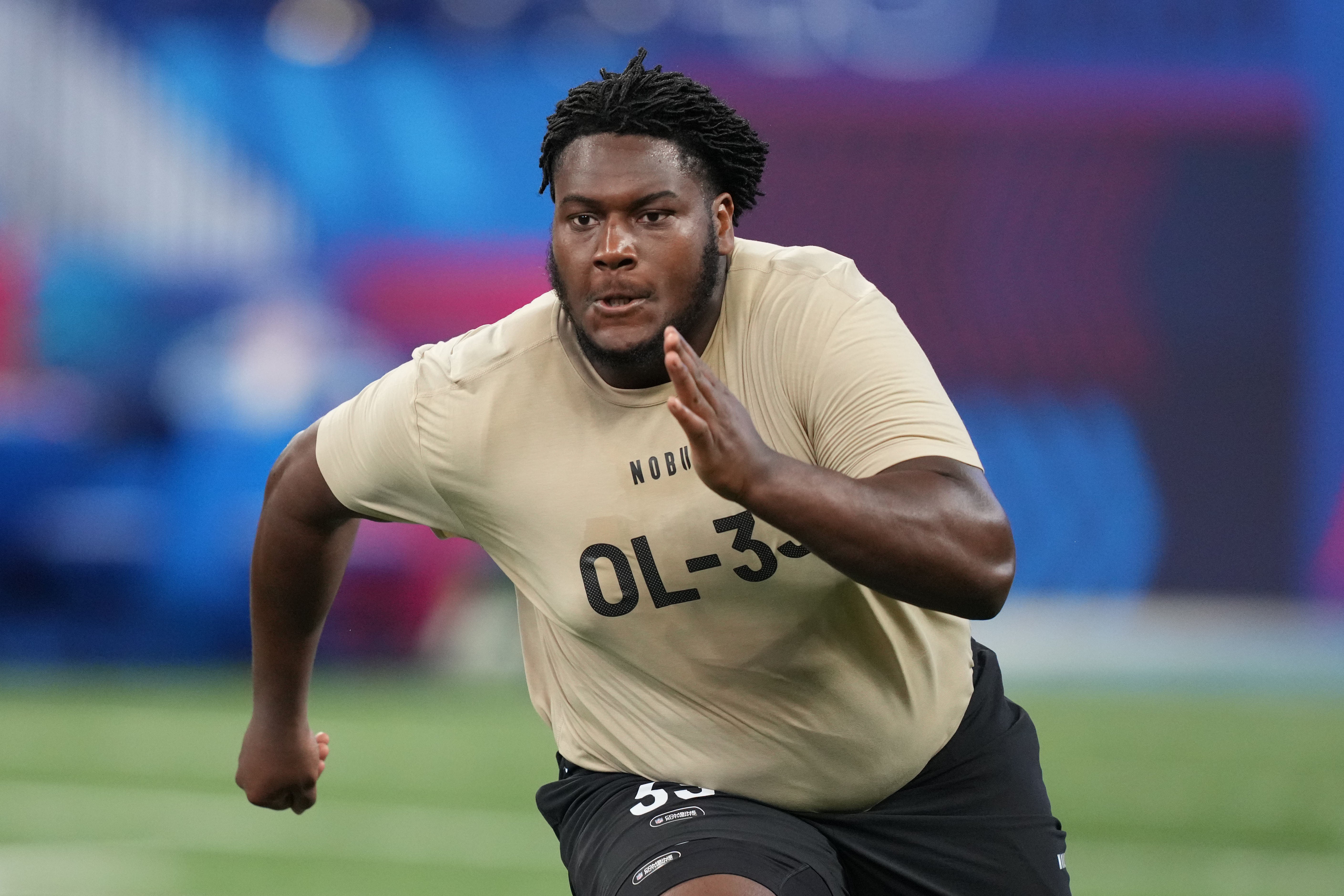 Mar 3, 2024; Indianapolis, IN, USA; Connecticut offensive lineman Christian Haynes (OL33) during the 2024 NFL Combine at Lucas Oil Stadium. 