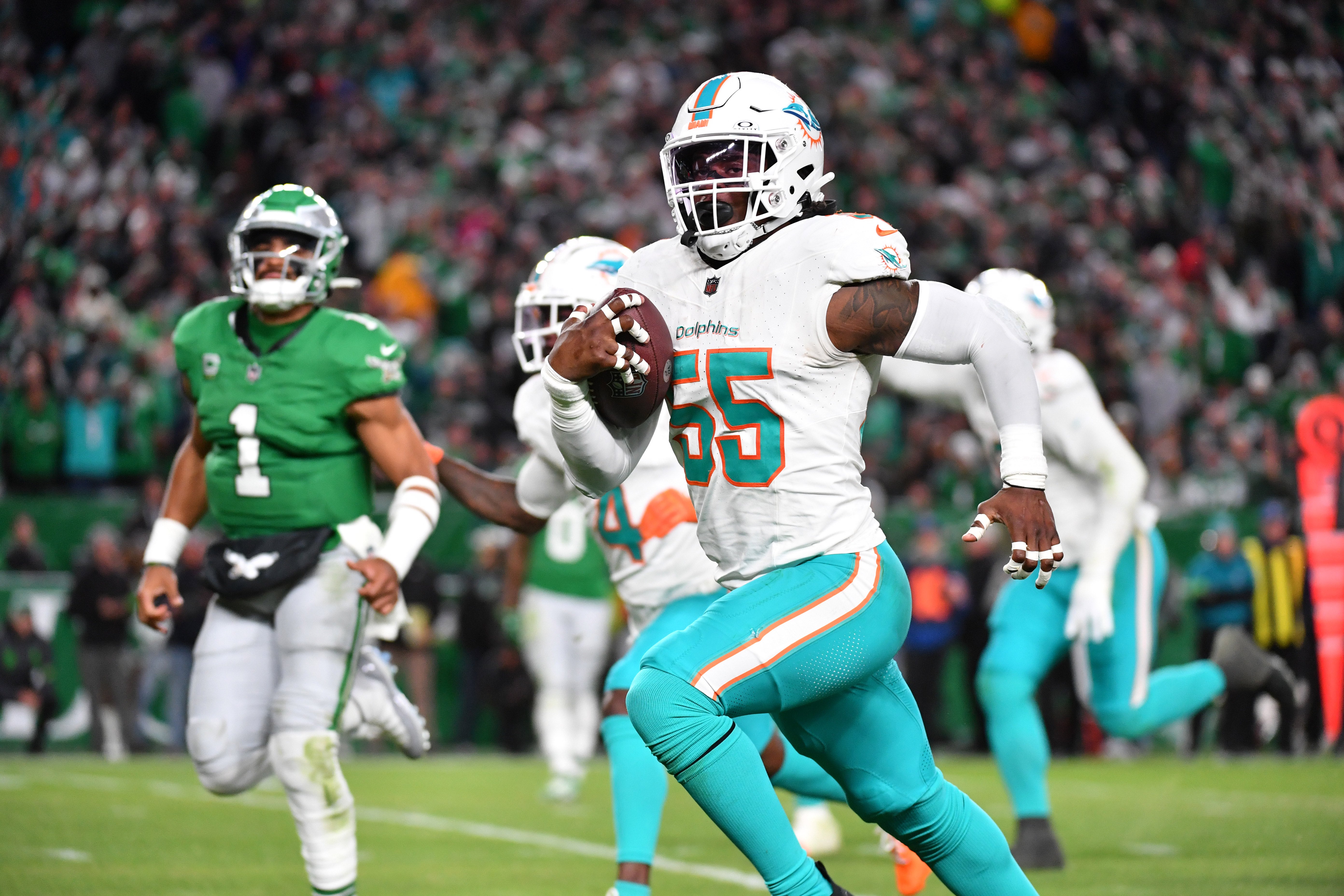 Oct 22, 2023; Philadelphia, Pennsylvania, USA; Miami Dolphins linebacker Jerome Baker (55) returns an interception for a touchdown during the third quarter against the Philadelphia Eagles at Lincoln Financial Field.