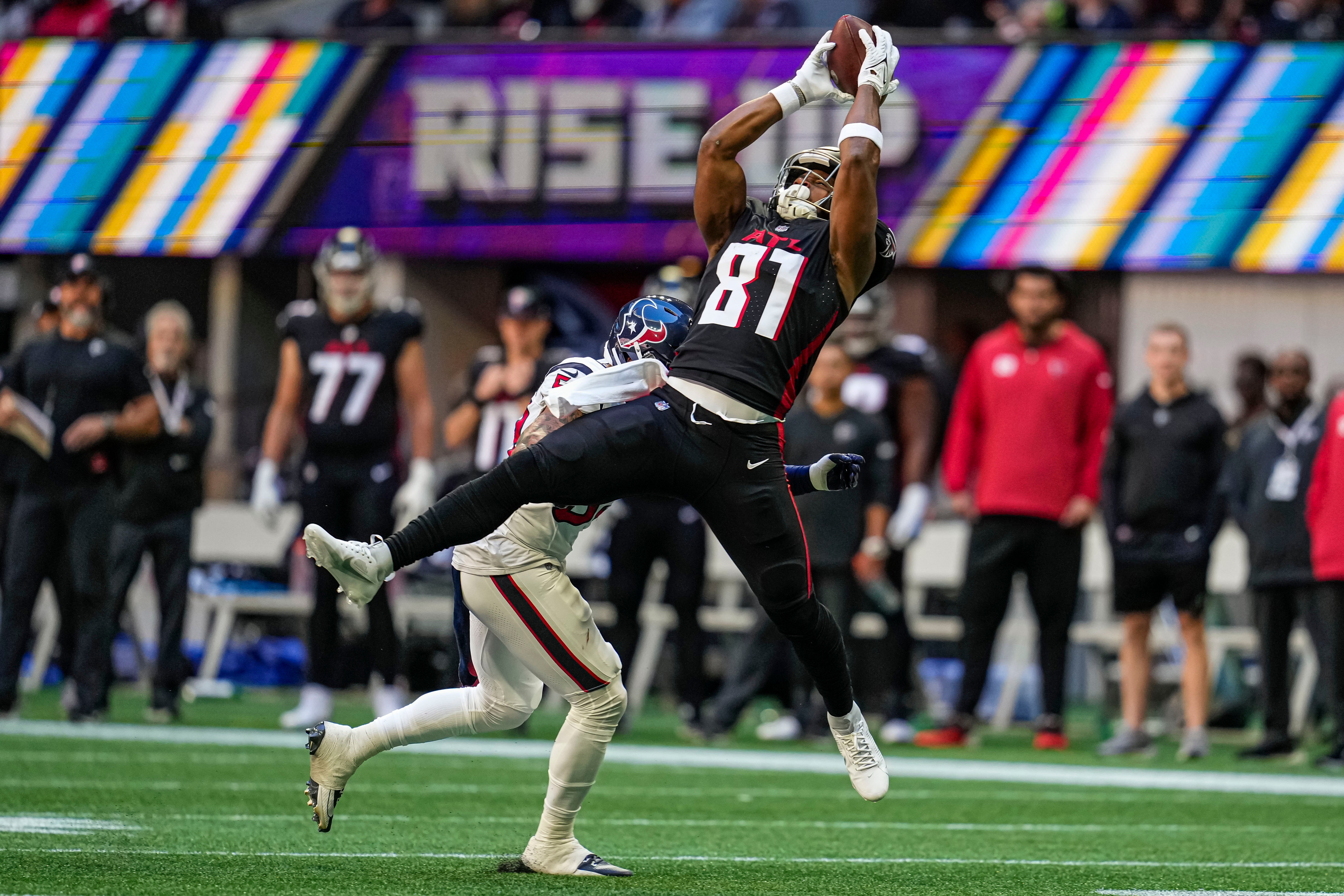 Oct 8, 2023; Atlanta, Georgia, USA; Atlanta Falcons tight end Jonnu Smith (81) makes a catch over top of Houston Texans safety Jalen Pitre (5) during the first half at Mercedes-Benz Stadium.