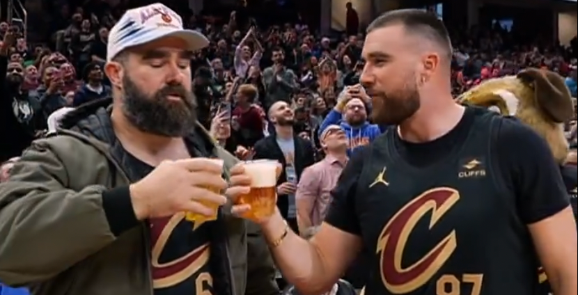 Jason and Travis Kelce chug beers at the Cleveland Cavaliers game.