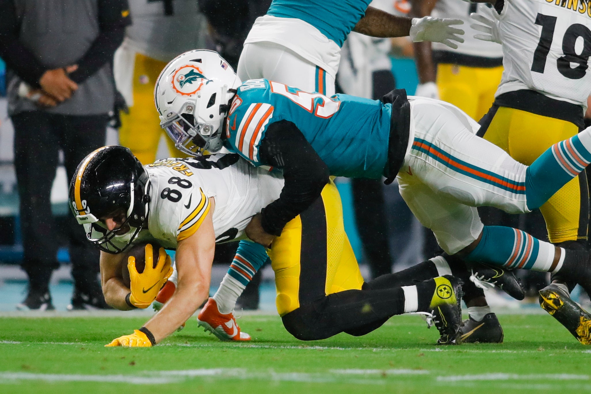 Oct 23, 2022; Miami Gardens, Florida, USA; Miami Dolphins linebacker Jerome Baker (55) tackles Pittsburgh Steelers tight end Pat Freiermuth (88) during the third quarter at Hard Rock Stadium. Mandatory Credit: Sam Navarro-USA TODAY Sports
