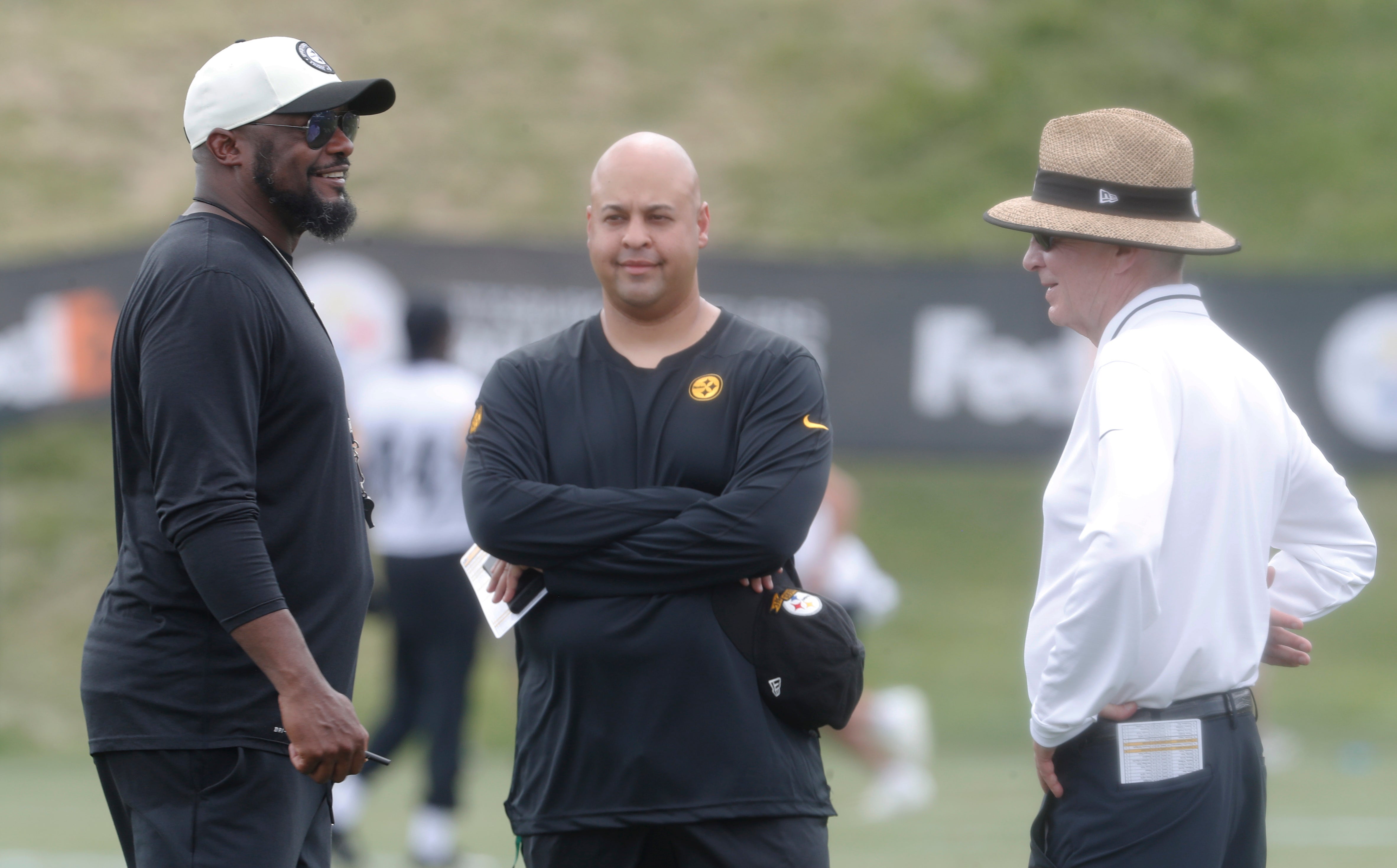 Jul 27, 2023; Latrobe, PA, USA; Pittsburgh Steelers head coach Mike Tomlin (left) and general manager Omar Khan (middle) and chairman Art Rooney II talk on the field during training camp at Saint Vincent College. Mandatory Credit: Charles LeClaire-USA TODAY Sports