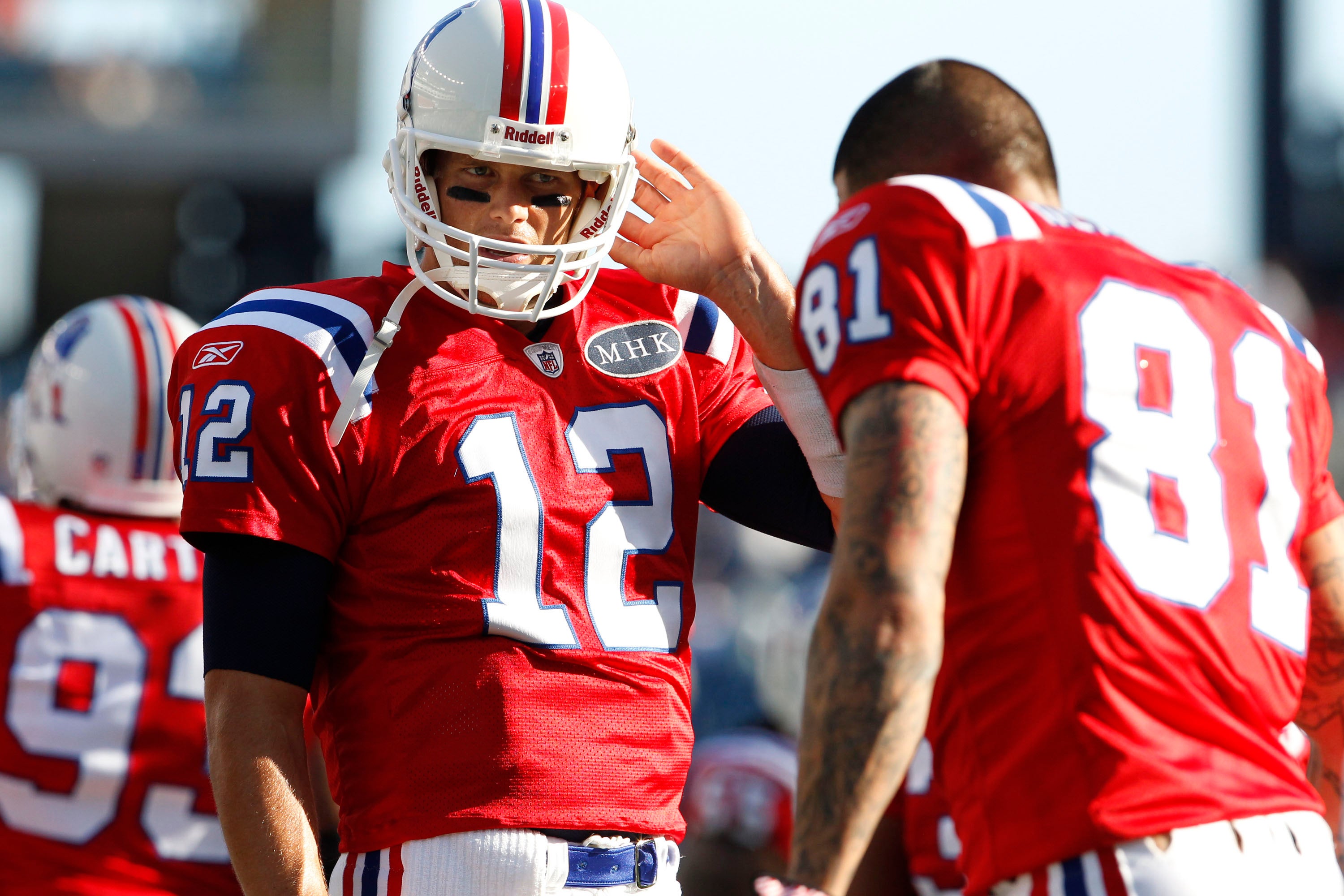 Oct 9, 2011; Foxborough, MA, USA; New England Patriots quarterback Tom Brady (12) talks with tight end Aaron Hernandez (81) as they warm up before the game against the New York Jets at Gillette Stadium