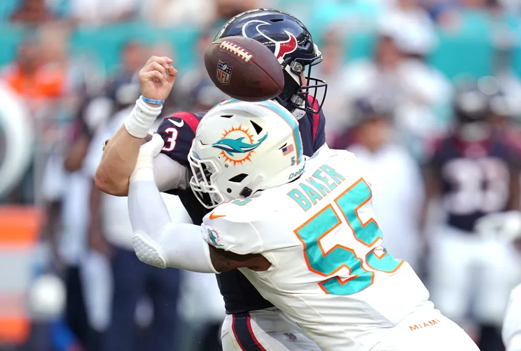Miami Dolphins linebacker Jerome Baker (55) knocks the ball out of Houston Texans quarterback Kyle Allen s (3) hands during the second half of an NFL game at Hard Rock Stadium in Miami Gardens, Nov....