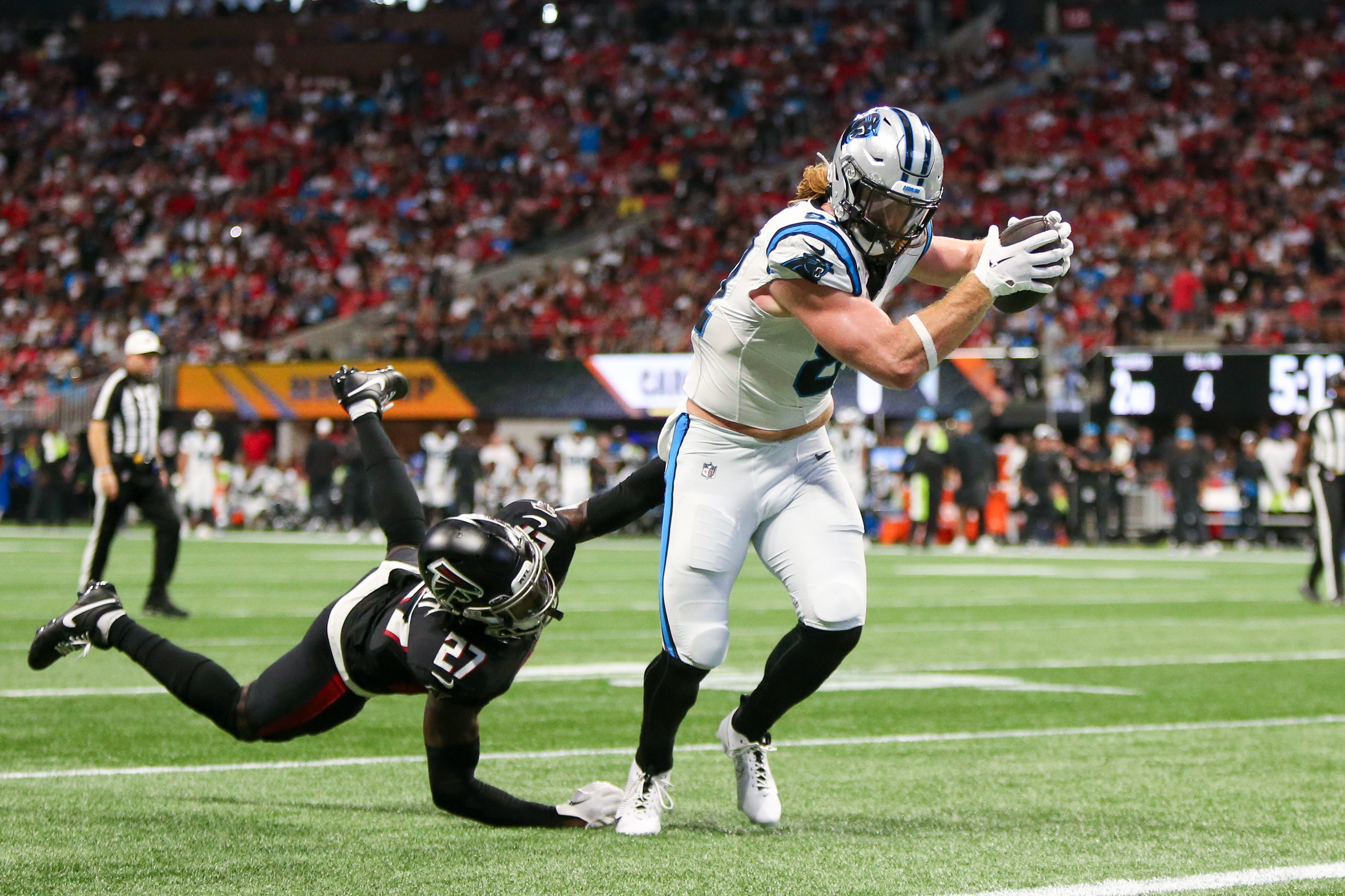 Sep 10, 2023; Atlanta, Georgia, USA; Carolina Panthers tight end Hayden Hurst (81) breaks away from Atlanta Falcons safety Richie Grant (27) for a touchdown in the second quarter at Mercedes-Benz Stadium. Mandatory Credit: Brett Davis-USA TODAY Sports