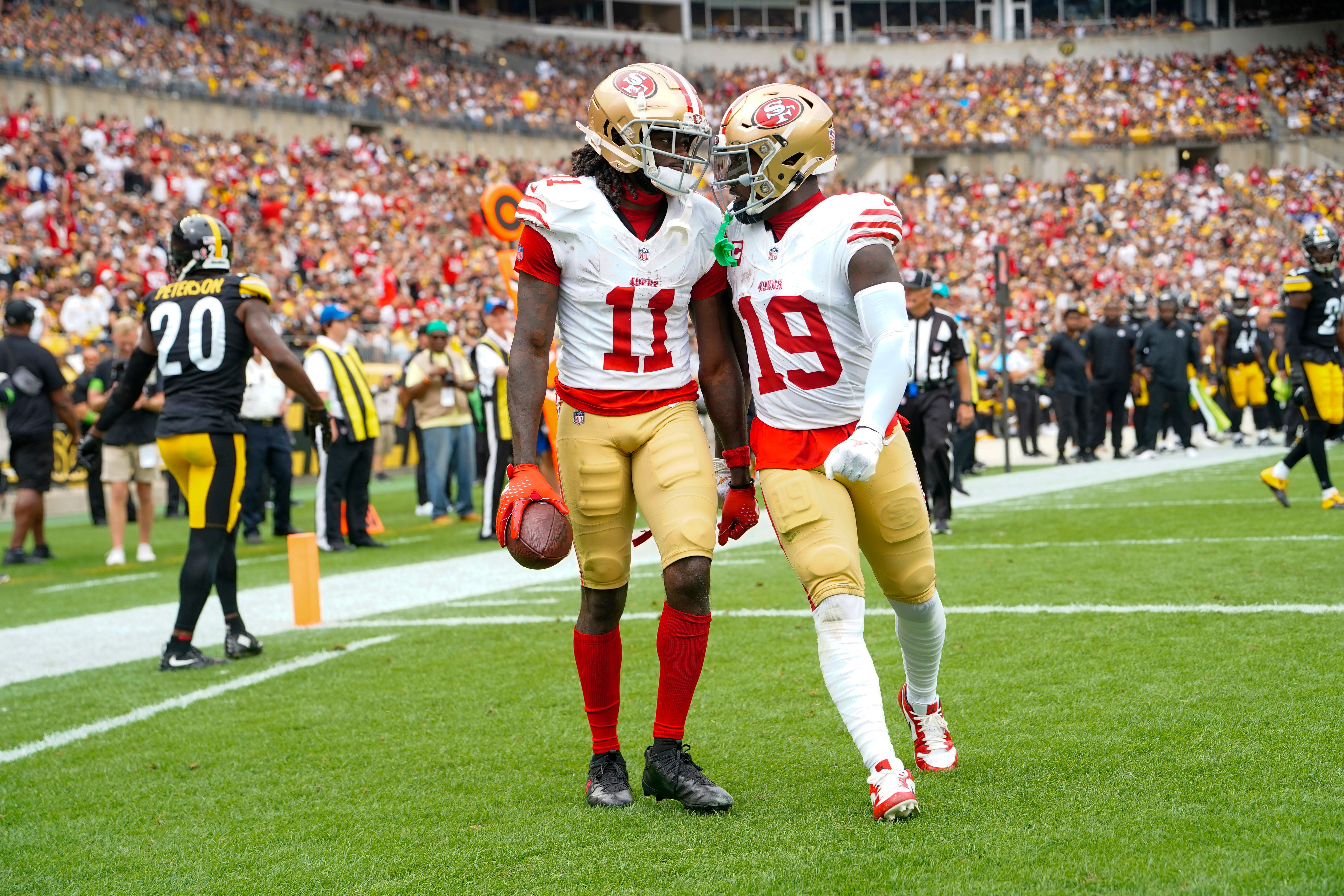 Sep 10, 2023; Pittsburgh, Pennsylvania, USA; San Francisco 49ers wide receiver Deebo Samuel (19) congratulates San Francisco 49ers wide receiver Brandon Aiyuk (11) for catching a touchdown pass against the Pittsburgh Steelers during the first half at Acrisure Stadium.