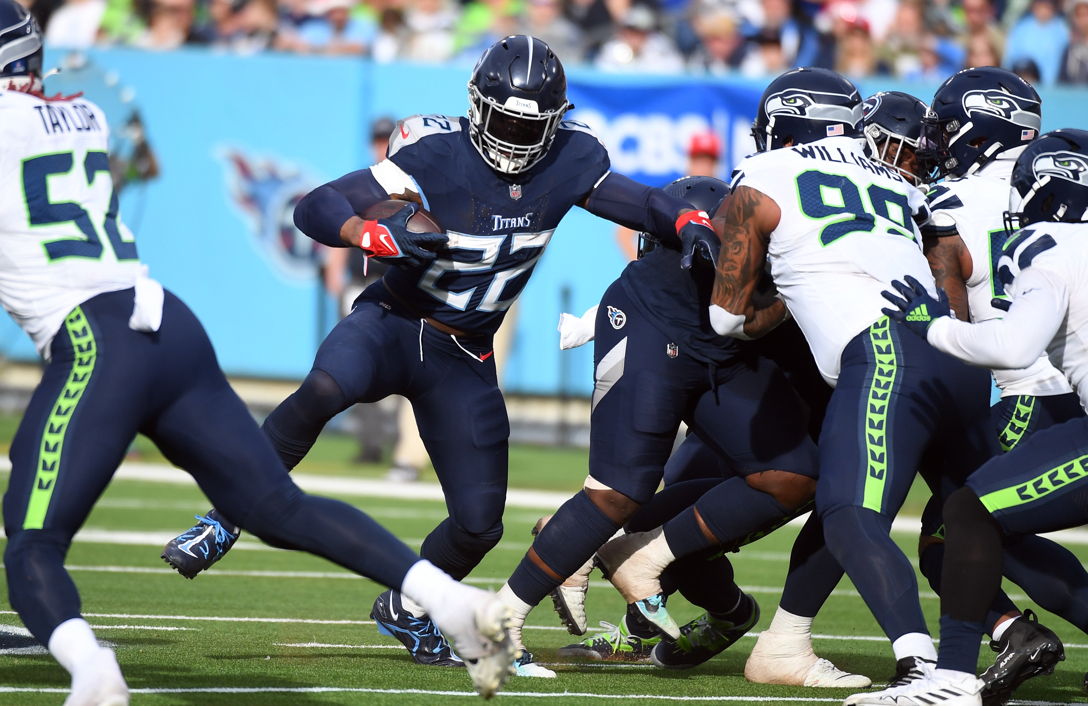 Tennessee Titans running back Derrick Henry (22) runs for a short gain during the second half against the Seattle Seahawks at Nissan Stadium.