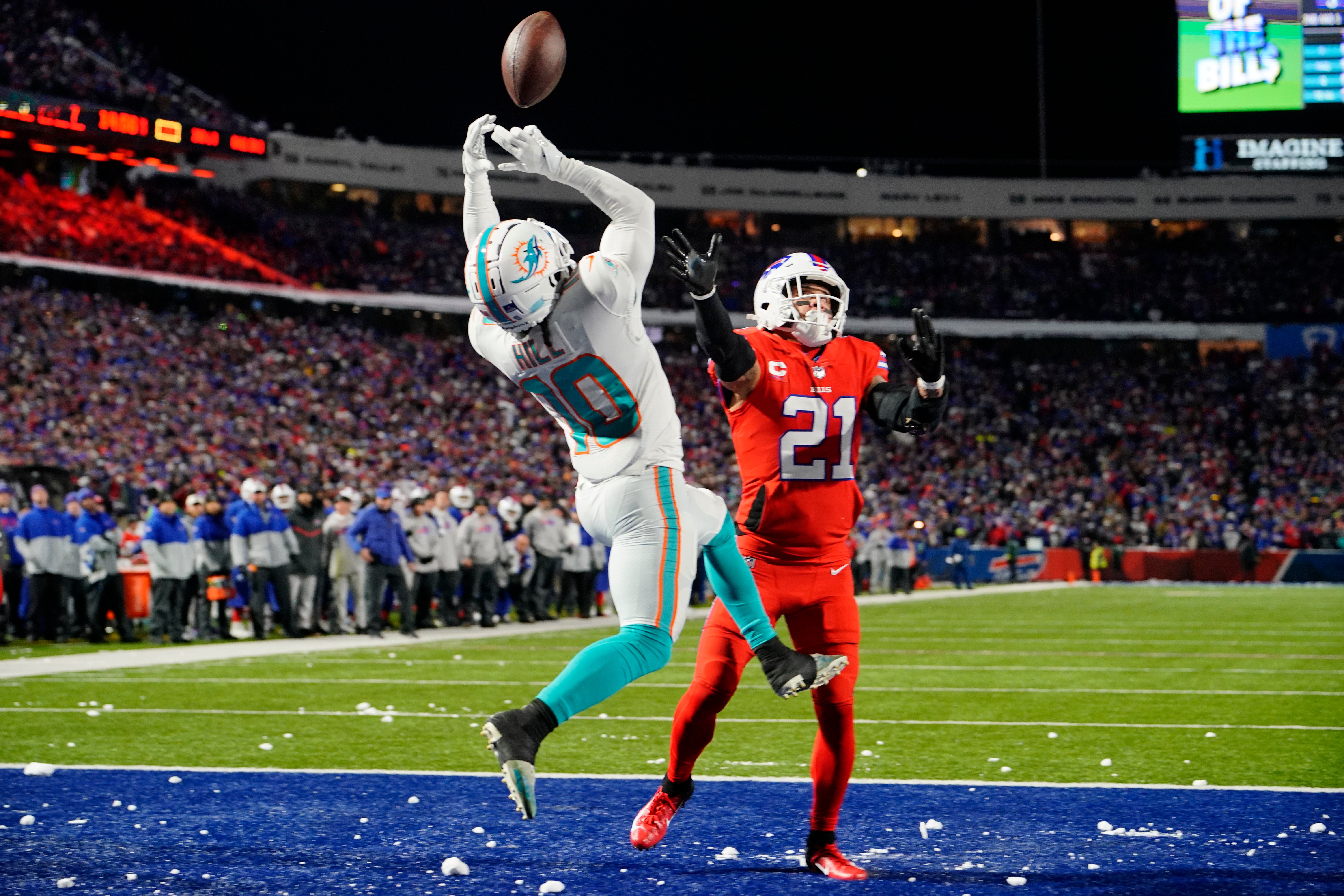 Dec 17, 2022; Orchard Park, New York, USA; Miami Dolphins wide receiver Tyreek Hill (10) attempts to catch a pass for a touchdown against Buffalo Bills safety Jordan Poyer (21) during the first half at Highmark Stadium.