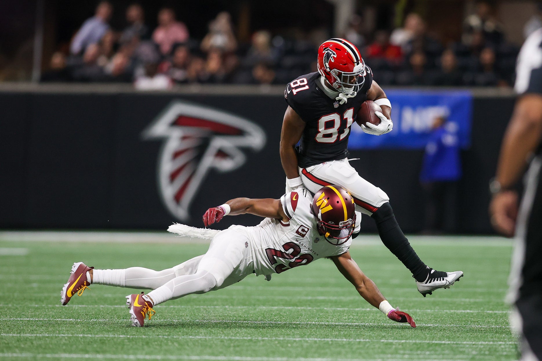 Oct 15, 2023; Atlanta, Georgia, USA; Atlanta Falcons tight end Jonnu Smith (81) is pushed out of bounds by Washington Commanders cornerback Kendall Fuller (29) in the second quarter at Mercedes-Benz Stadium.