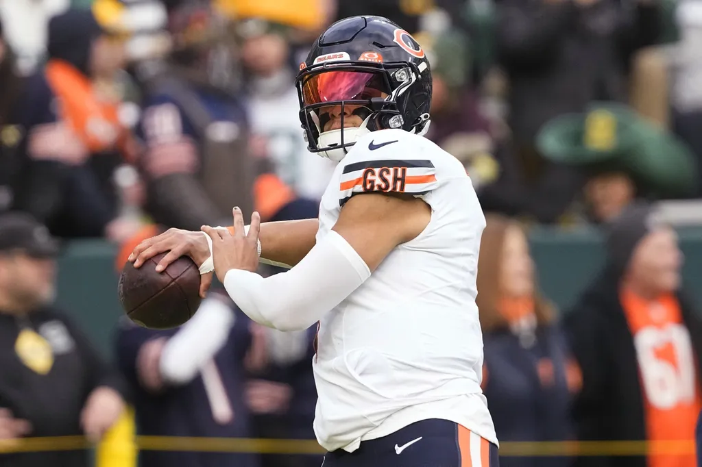 Chicago Bears quarterback Justin Fields (1) throws a pass during warmups prior to the game against the Green Bay Packers at Lambeau Field.
