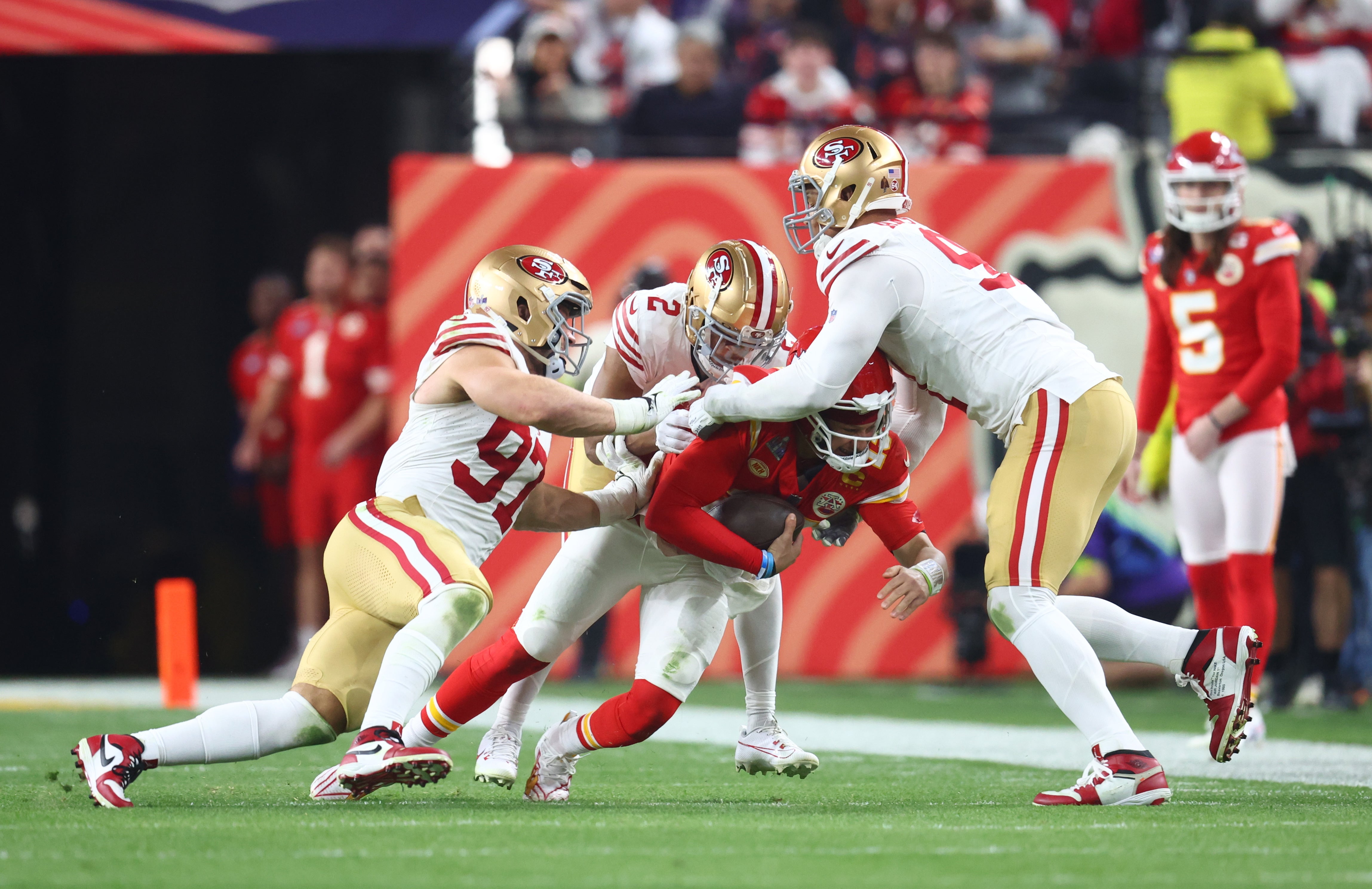 Feb 11, 2024; Paradise, Nevada, USA; Kansas City Chiefs quarterback Patrick Mahomes (15) is tackled by San Francisco 49ers defensive end Arik Armstead (91), defensive end Nick Bosa (97) and cornerback Deommodore Lenoir (2) in the second half in Super Bowl LVIII at Allegiant Stadium.