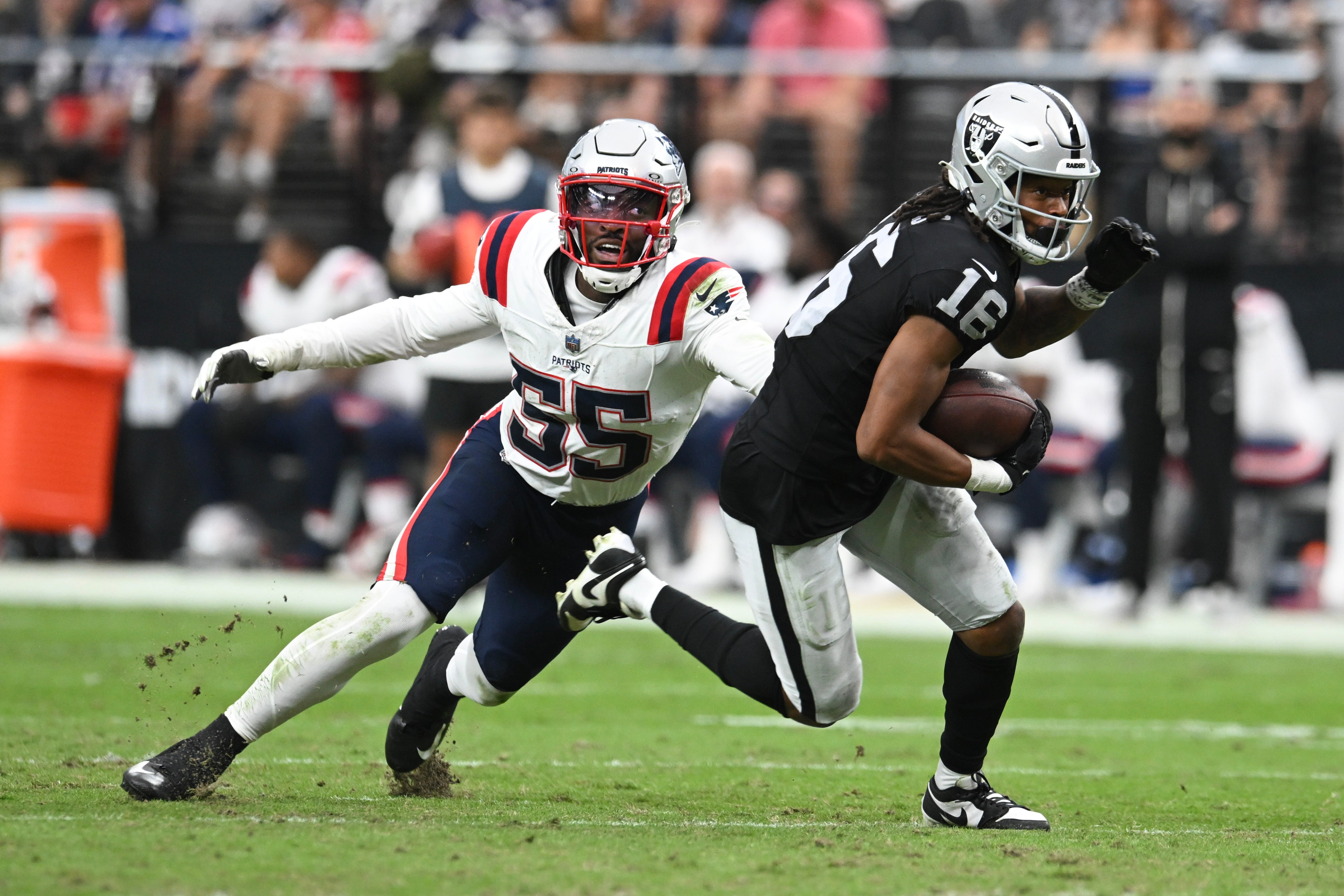 Oct 15, 2023; Paradise, Nevada, USA; New England Patriots linebacker Josh Uche (55) tries to tackle Las Vegas Raiders wide receiver Jakobi Meyers (16) in the second quarter at Allegiant Stadium.