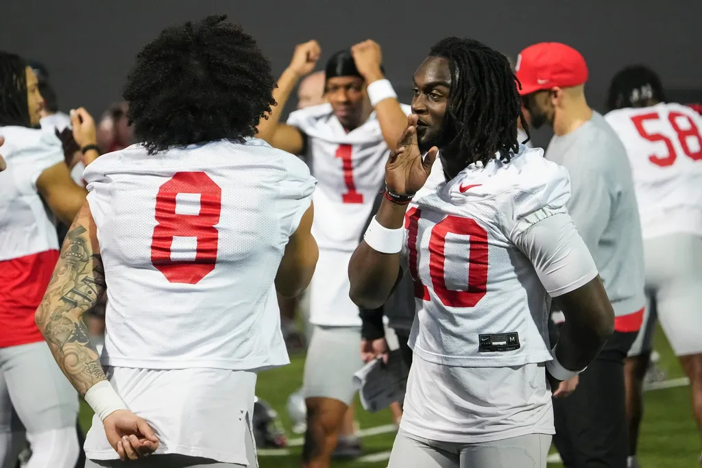 Ohio State Buckeyes cornerback Denzel Burke (10) does a handshake with safety Lathan Ransom (8) during spring football practice at the Woody Hayes Athletic Center