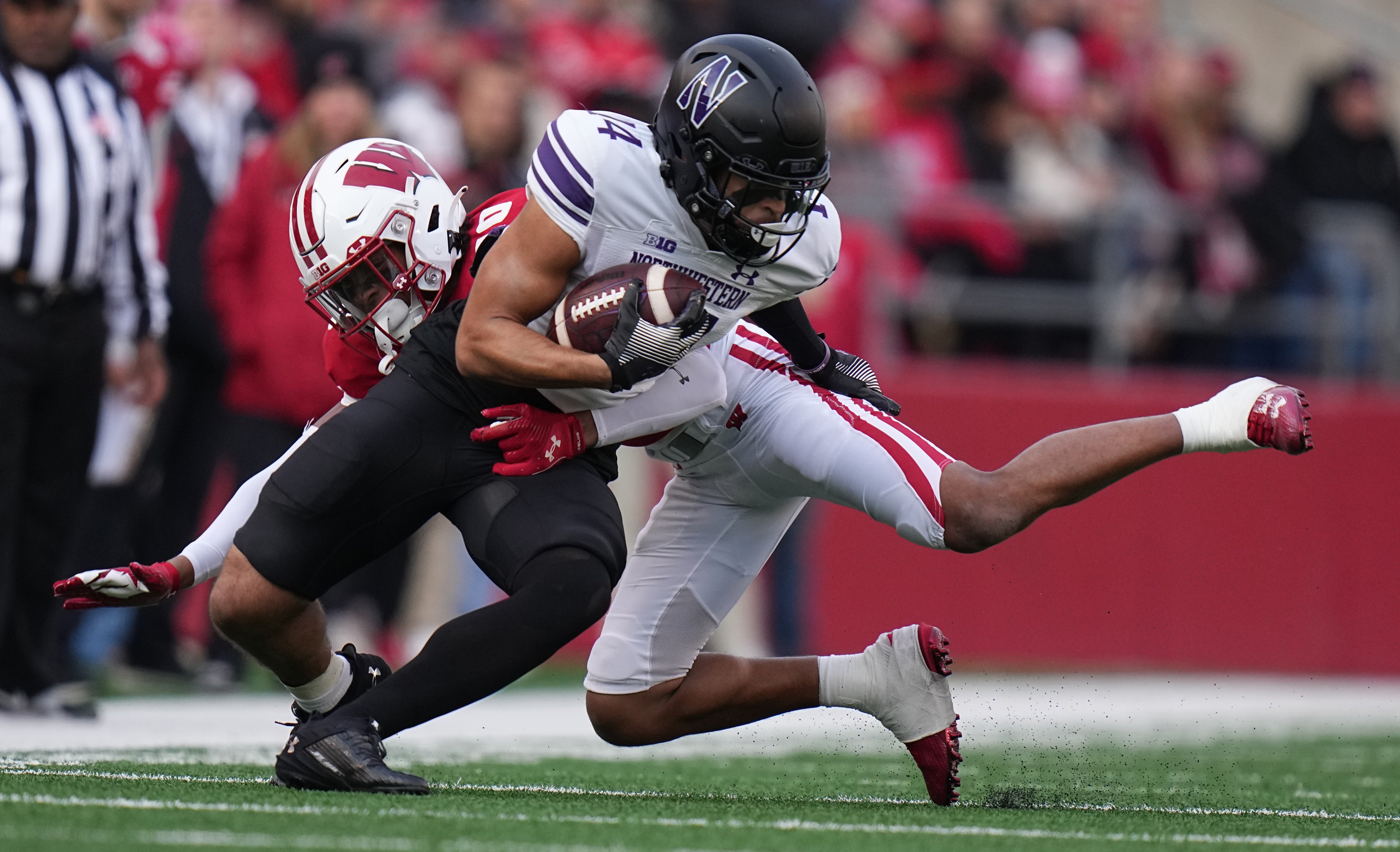 Wisconsin Badgers cornerback Nyzier Fourqurean (10) tackles Northwestern Wildcats wide receiver Cam Johnson (14) during the first quarter at Camp Randall Stadium. Mark Hoffman-USA TODAY Sports