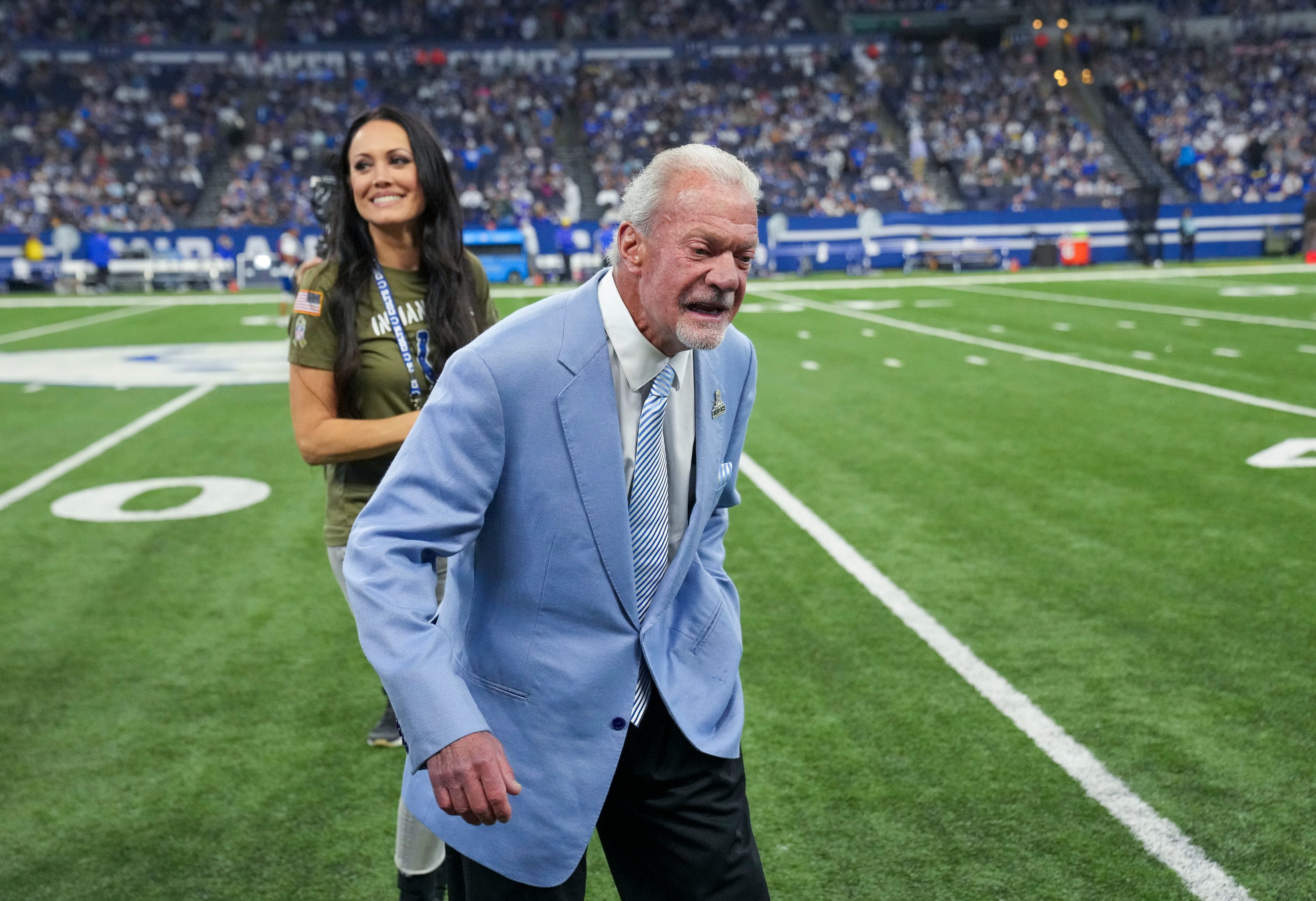Jim Irsay, Colts team owner, walks to a waiting golf cart with his girlfriend Michelle Paul, on Sunday, Oct. 1, 2023, during a halftime event during the team s 29-23 loss to the Los Angeles Rams at Lucas Oil Stadium in Indianapolis.