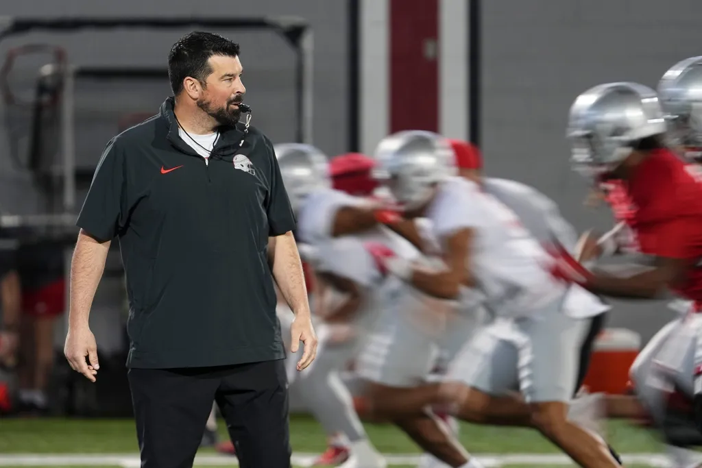 Ohio State Buckeyes head coach Ryan Day watches players run during spring football practice at the Woody Hayes Athletic Center