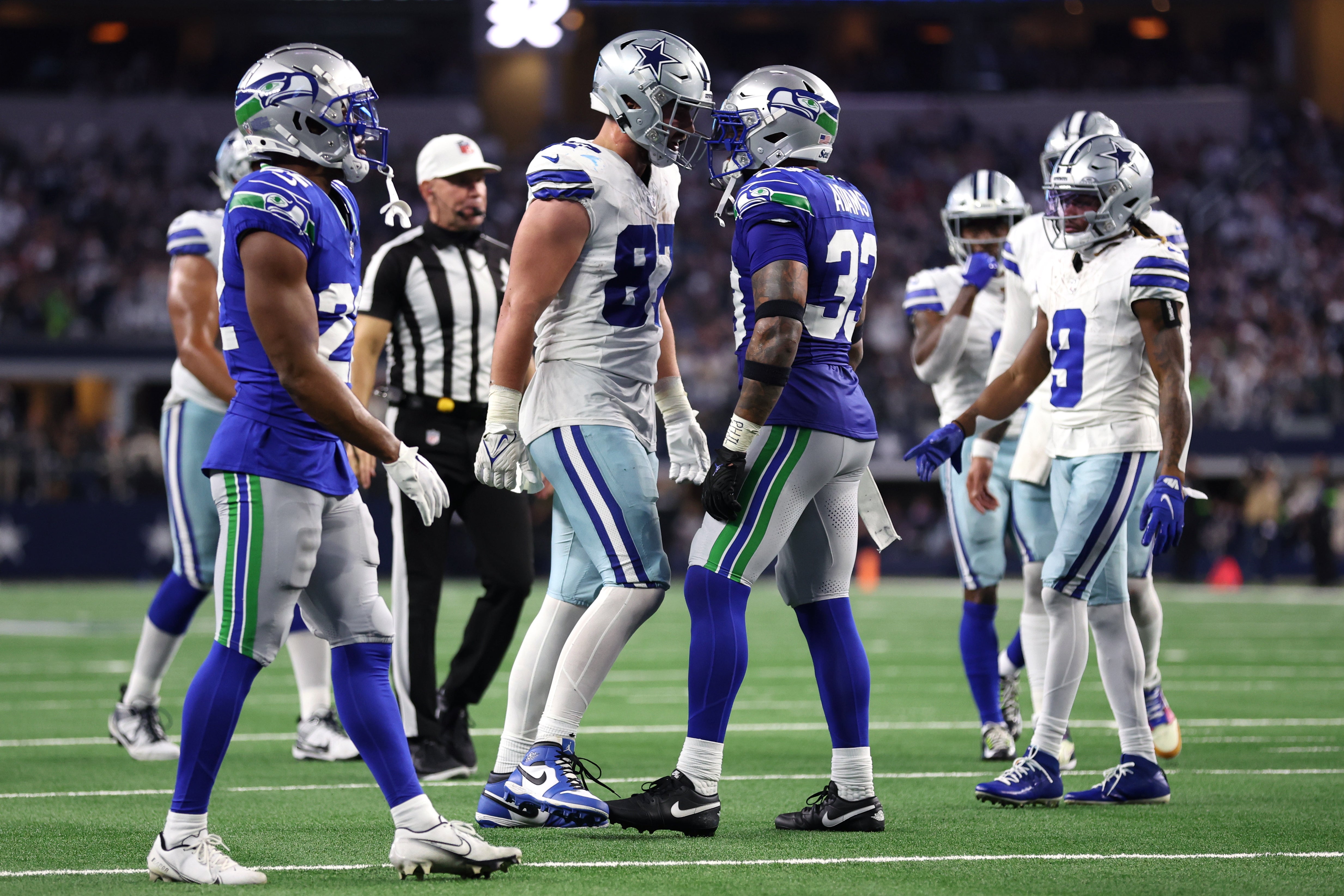 Dallas Cowboys tight end Jake Ferguson (87) and Seattle Seahawks safety Jamal Adams (33) talks after a play during the second half at AT&T Stadium.