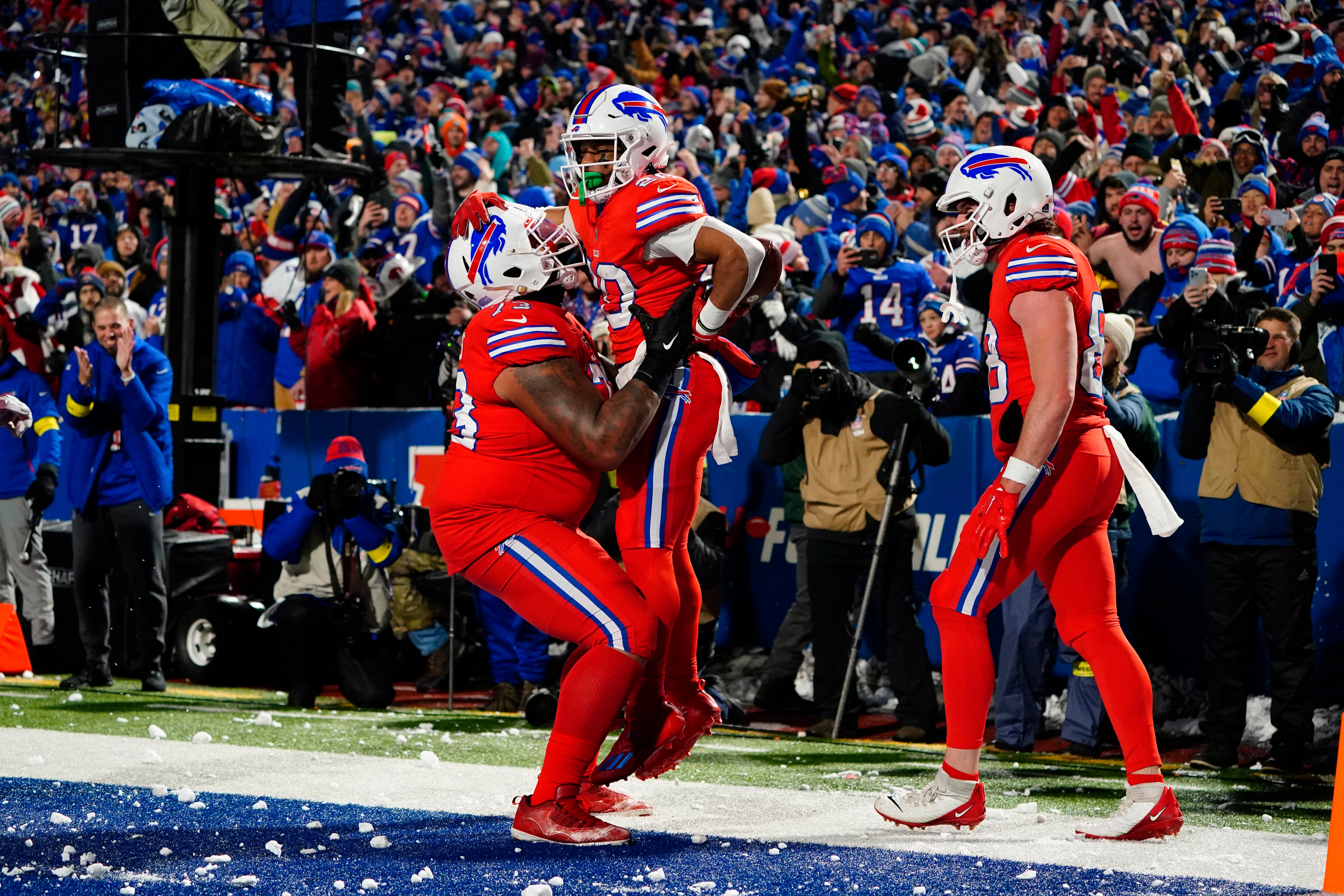 Buffalo Bills offensive tackle Dion Dawkins (73) congratulates Buffalo Bills running back Nyheim Hines (20) for scoring a touchdown against the Miami Dolphins during the first half at Highmark Stadium.