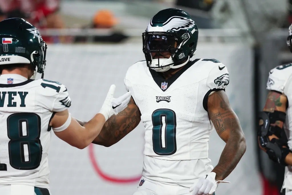 Philadelphia Eagles running back D'Andre Swift (0) greets wide receiver Britain Covey (18) during warm ups before a 2024 NFC wild card game at Raymond James Stadium.
