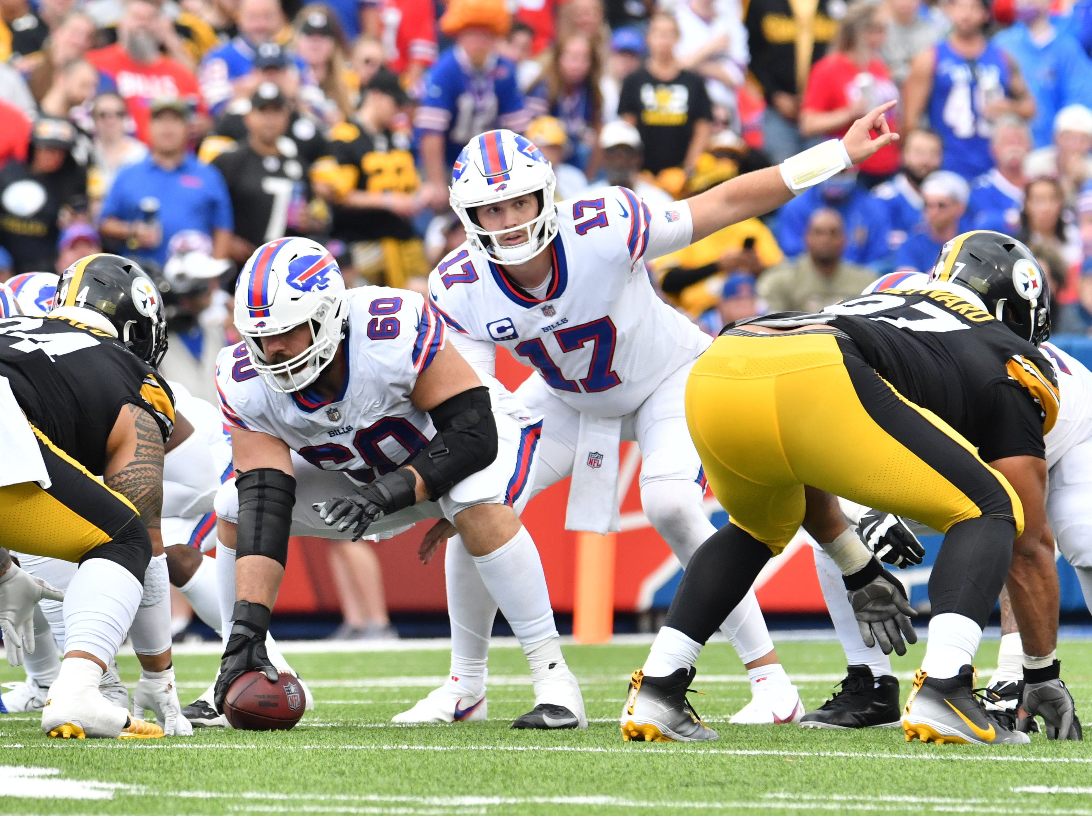 Sep 12, 2021; Orchard Park, New York, USA; Buffalo Bills quarterback Josh Allen (17) at the line of scrimmage with center Mitch Morse (60) against the Pittsburgh Steelers in the third quarter at Highmark Stadium. Mandatory Credit: Mark Konezny-USA TODAY Sports  