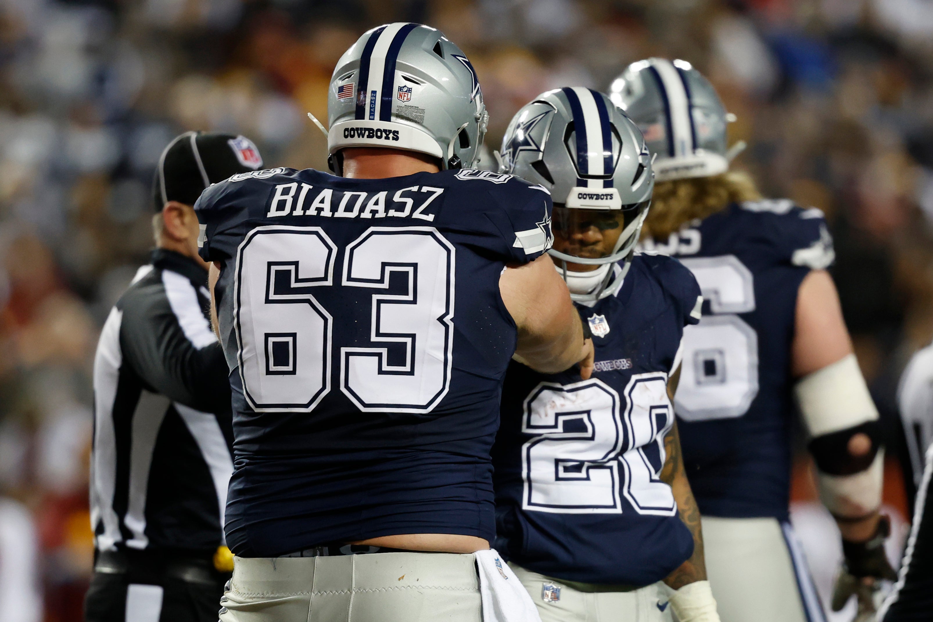Dallas Cowboys running back Tony Pollard (20) celebrates with Cowboys center Tyler Biadasz (63) after scoring a touchdown against the Washington Commanders during the second quarter at FedExField.