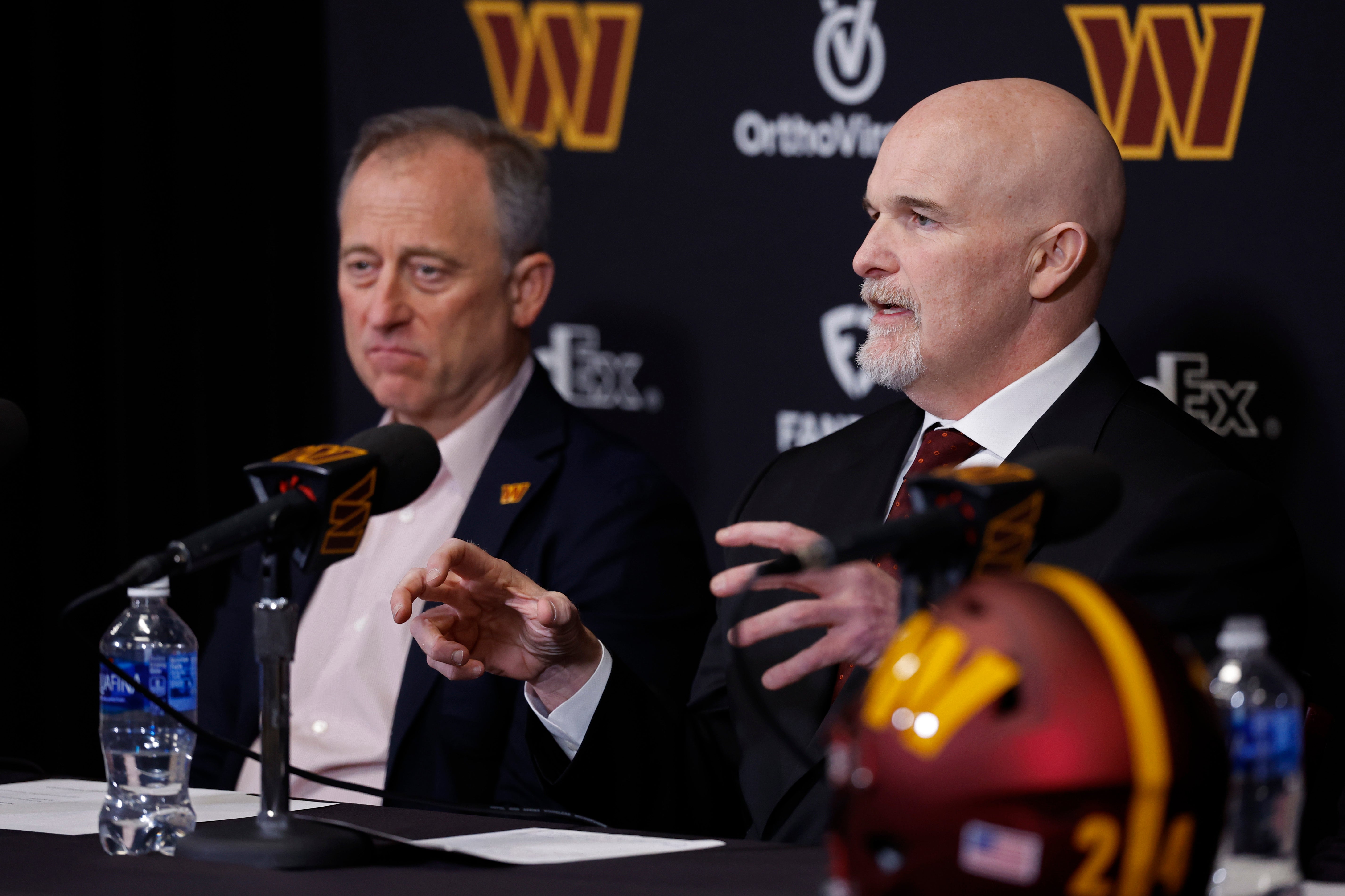 Feb 5, 2024; Ashburn, VA, USA; Washington Commanders majority owner Josh Harris (L) listens as Commanders head coach Dan Quinn (R) speaks during his introductory press conference at Commanders Park.