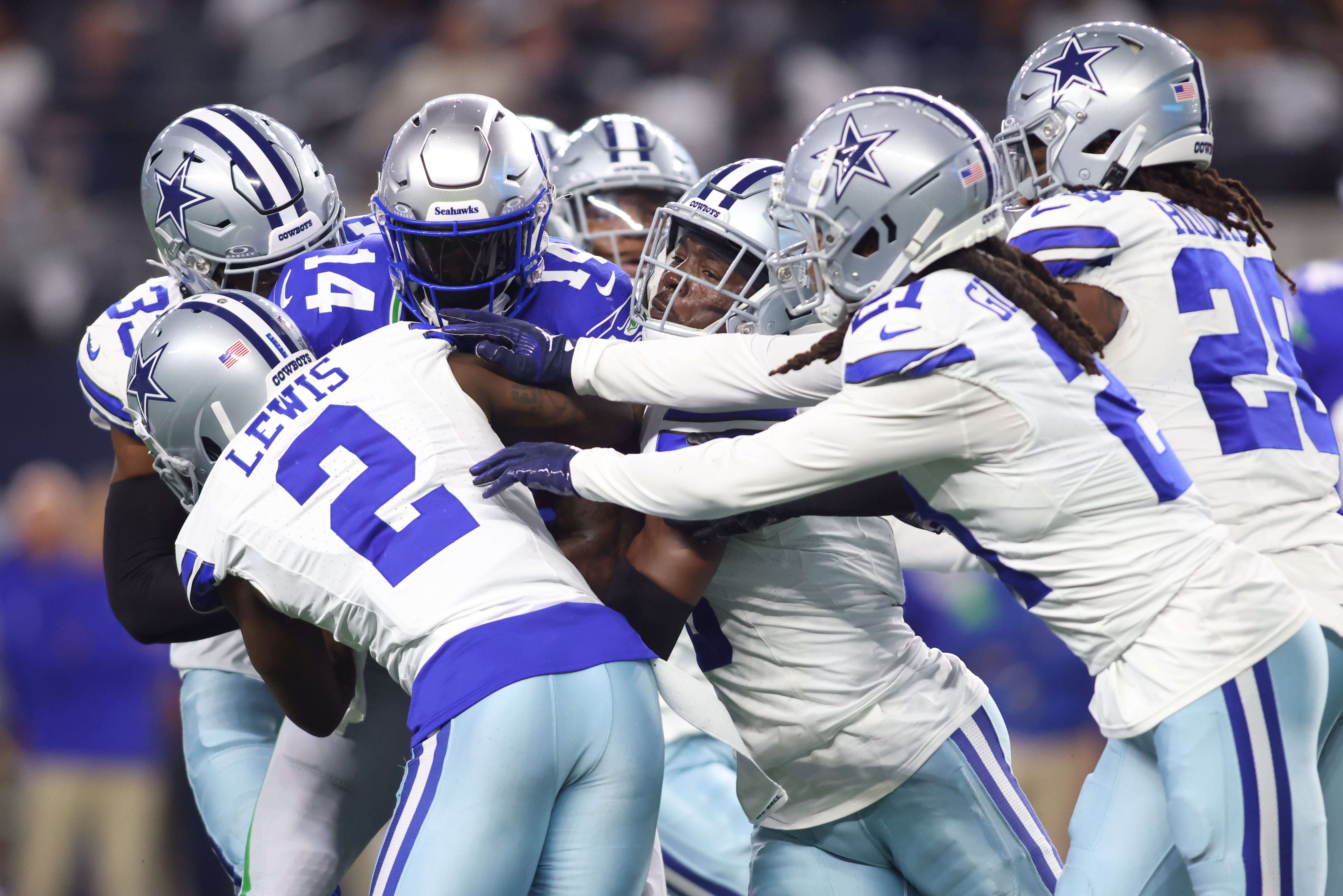 Seattle Seahawks wide receiver DK Metcalf (14) is tackled by Dallas Cowboys cornerback Jourdan Lewis (2) and cornerback Stephon Gilmore (21) during the first half at AT&T Stadium.